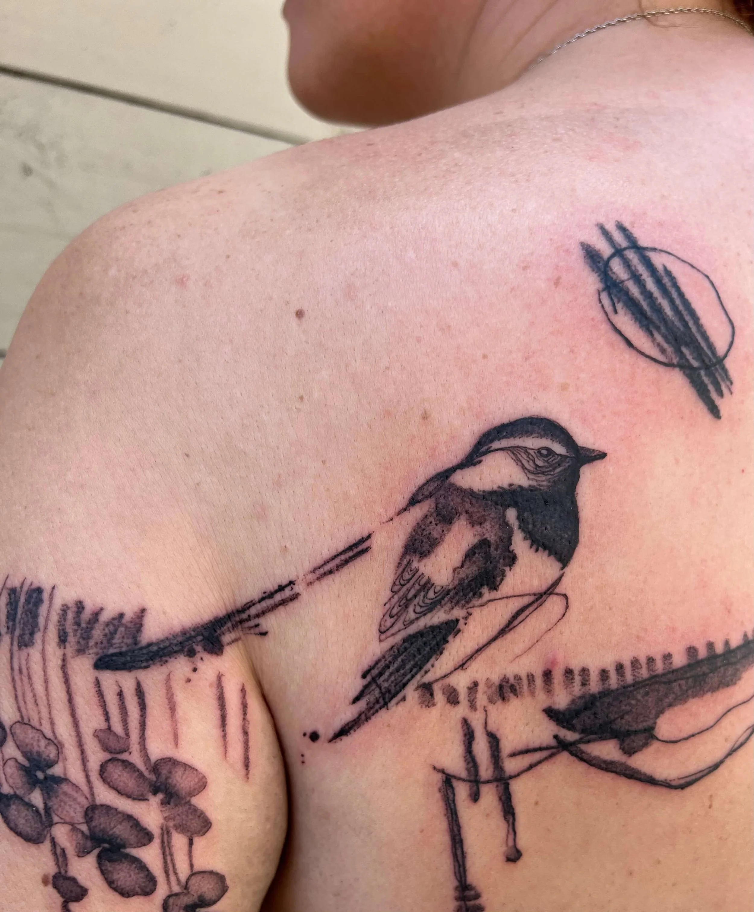 Contemporary abstract blackwork tattoo on the shoulder with layered line and structural composition.