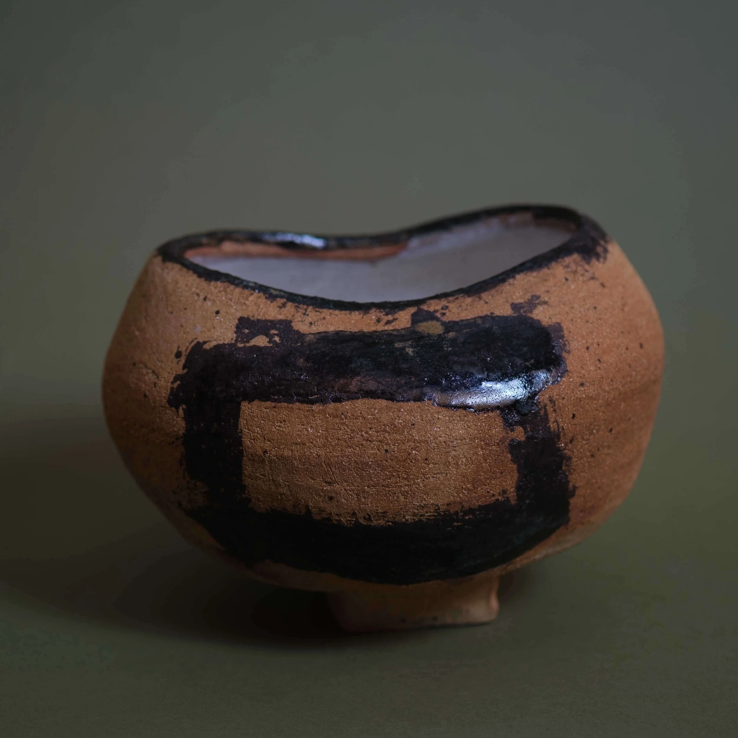 Trace contemporary ceramic vessel with organic curved silhouette and expressive black surface detailing