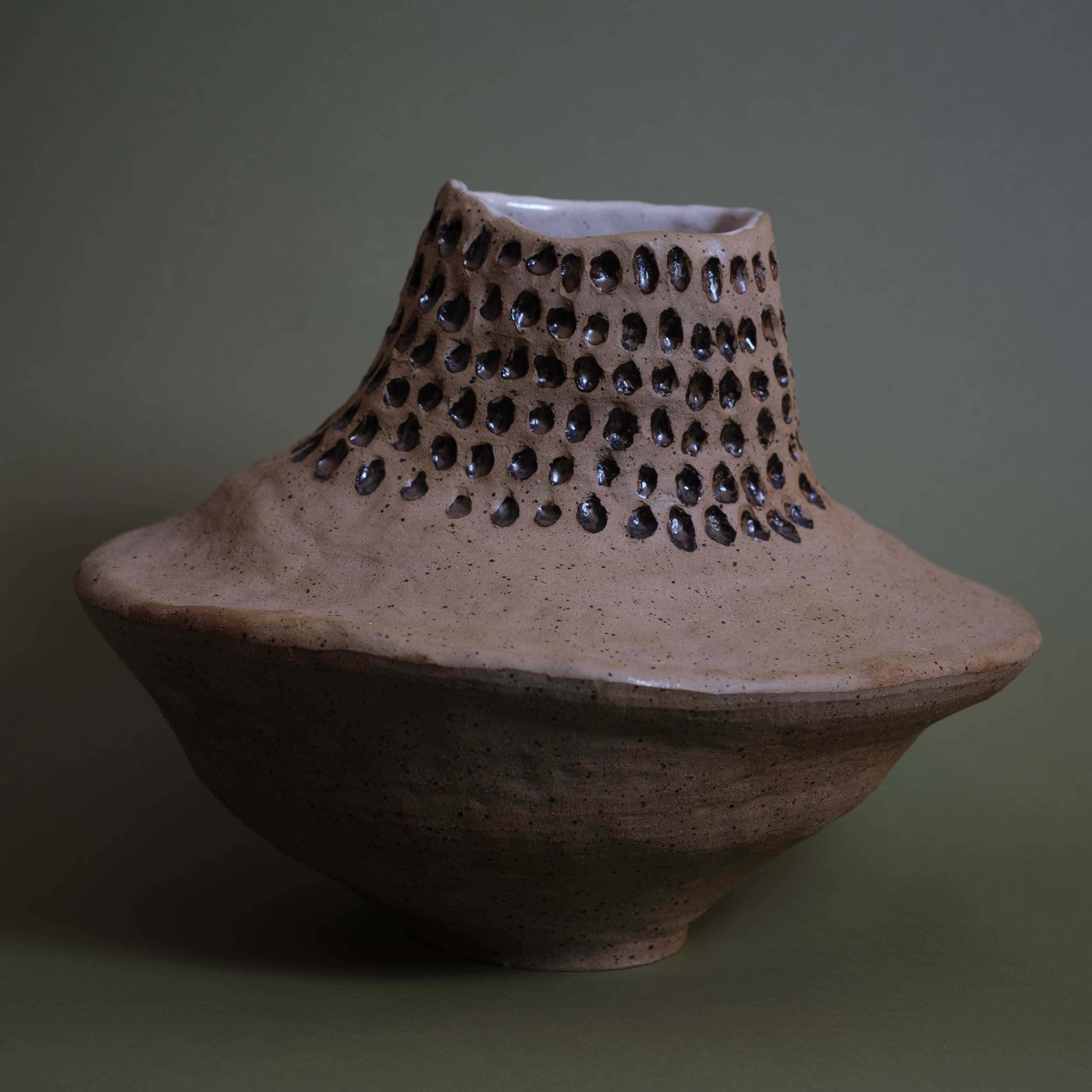 Dip in Space contemporary ceramic vessel with pierced surface detailing and organic architectural form
