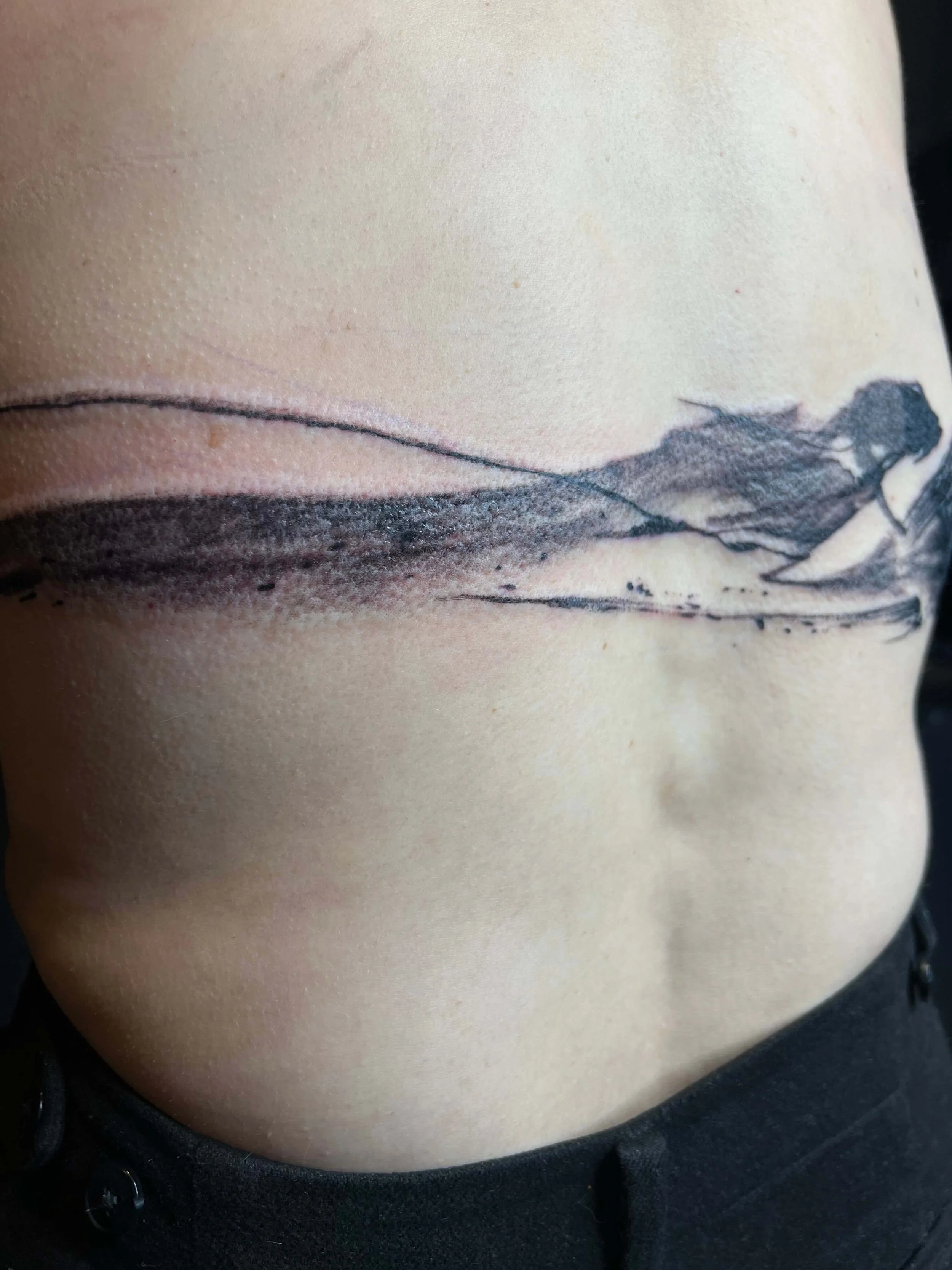 Contemporary black ink mountain design with subtle shading.