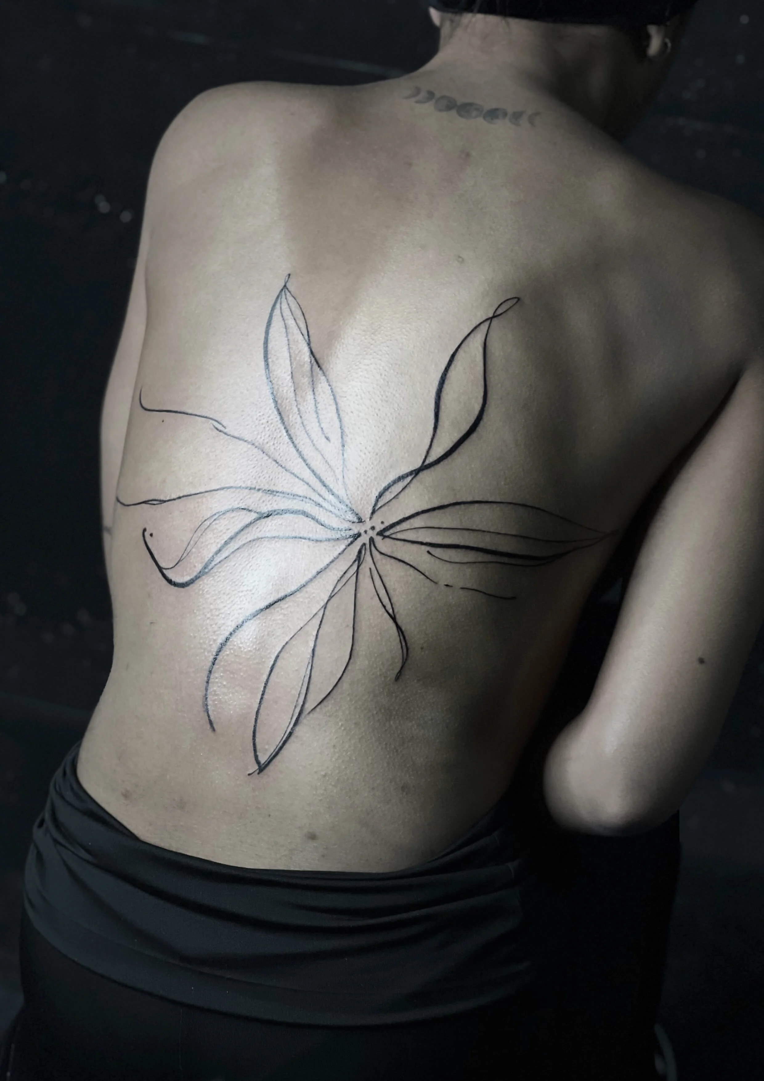 Delicate linework flower design with soft negative space composition.