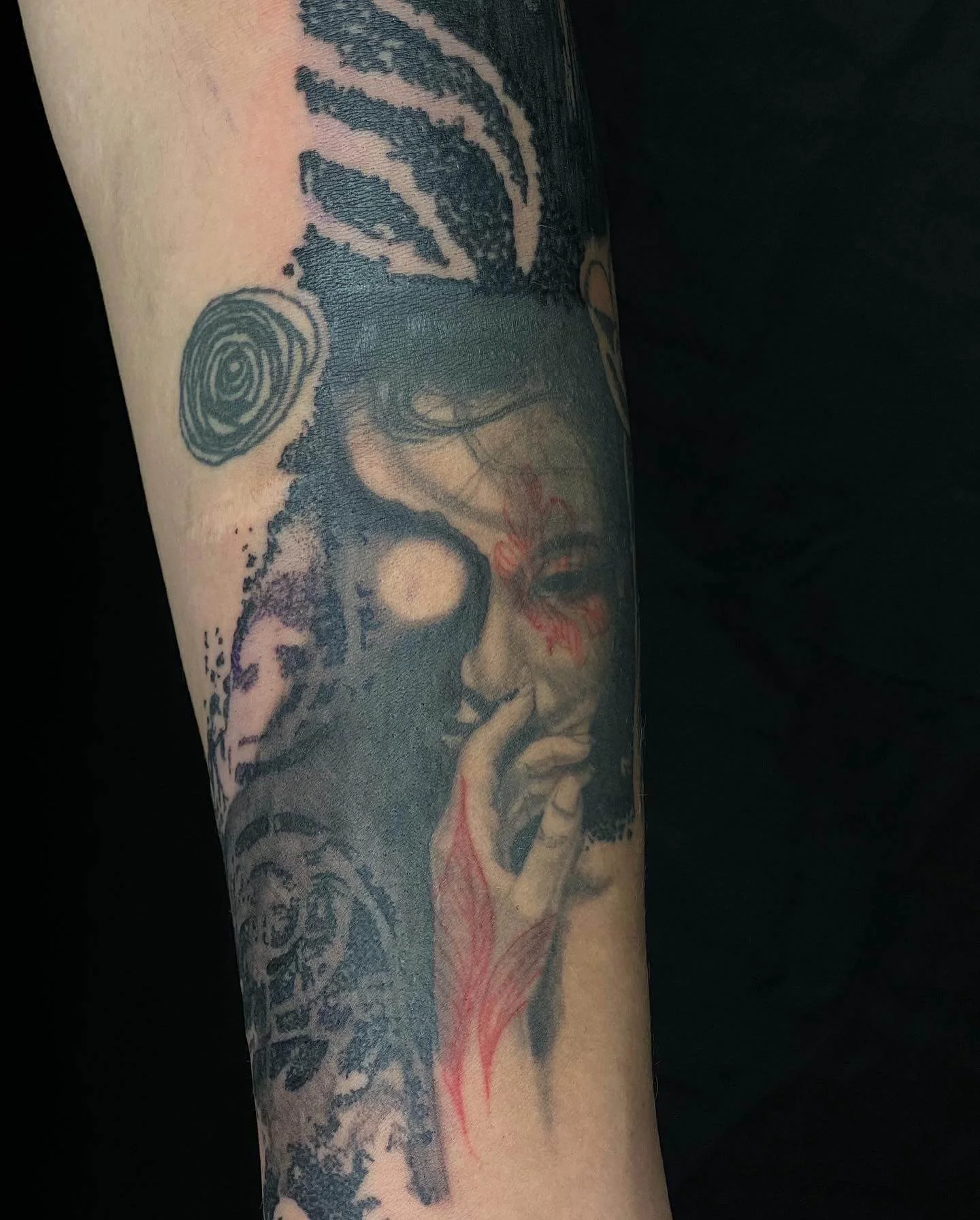 Contemporary abstract tattoo featuring a female portrait with geometric shapes and expressive red detailing.