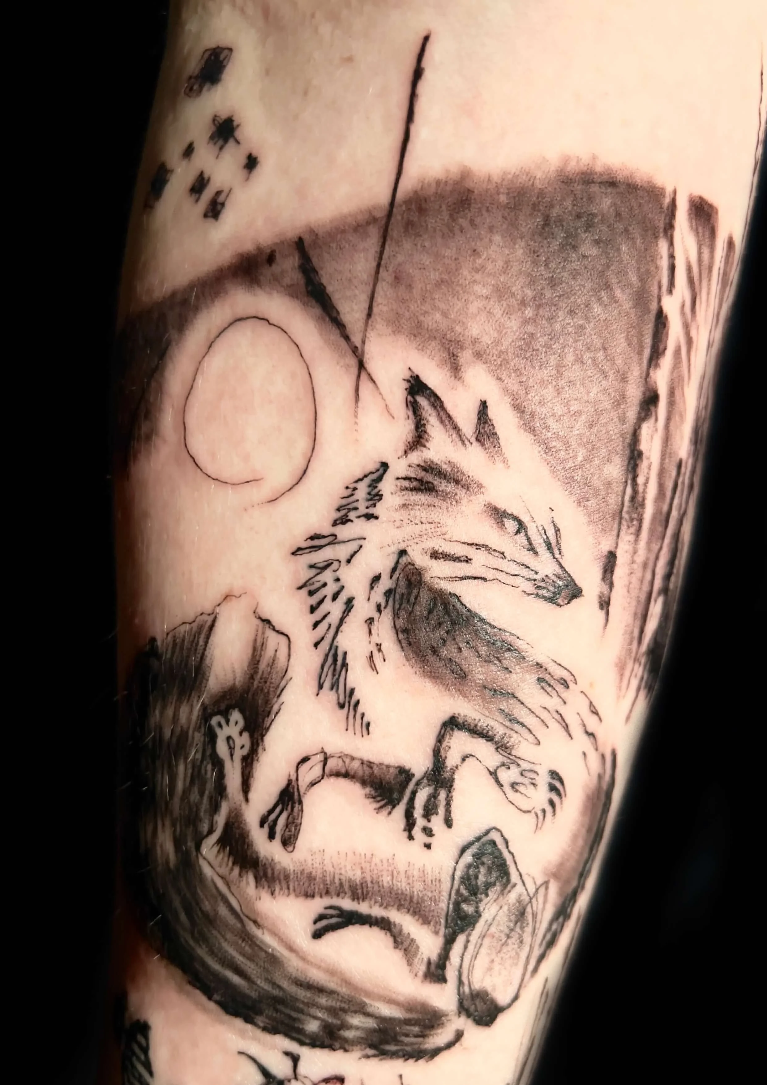 Black and grey fox under the moon tattoo with forest landscape detailing.