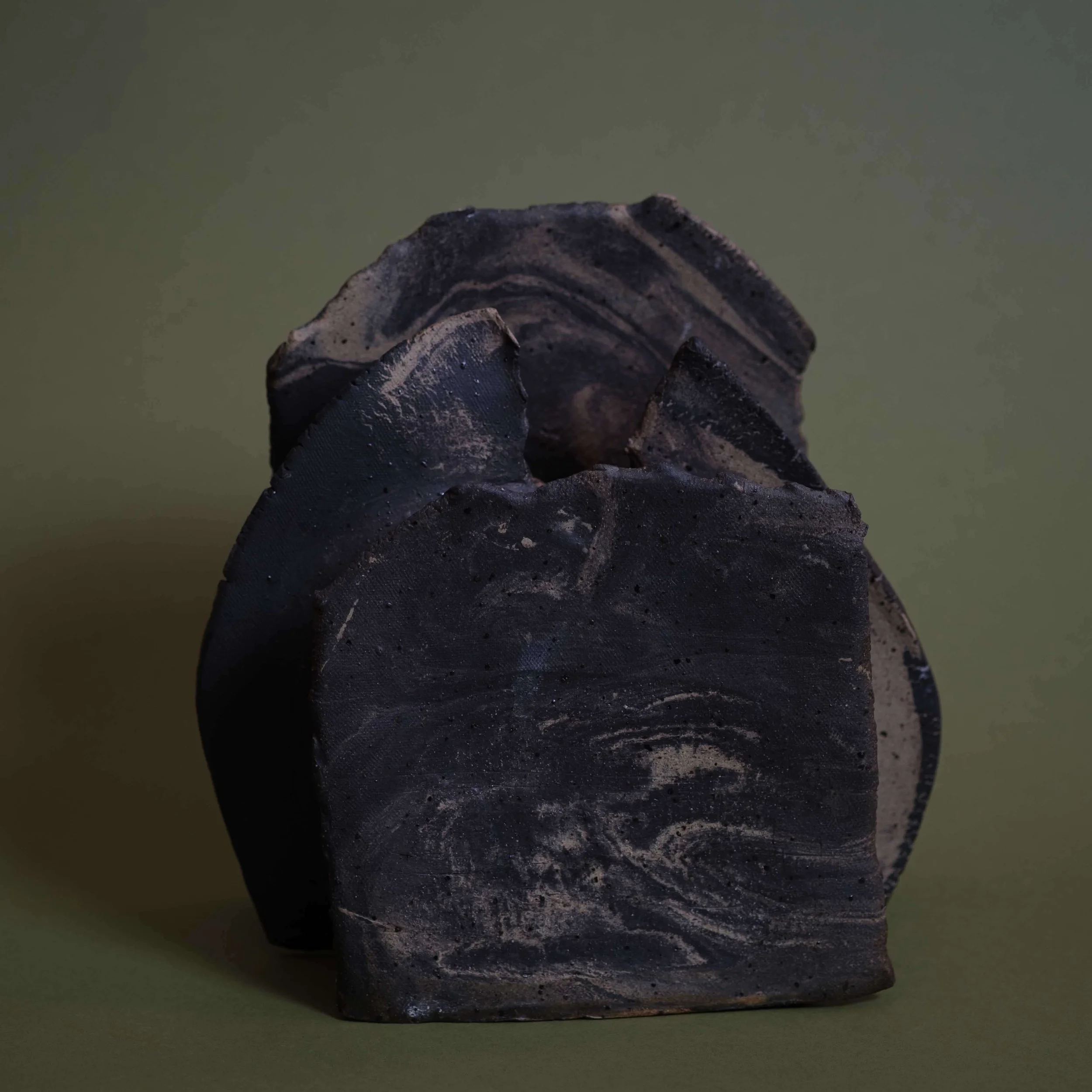 Mountain Vessel contemporary ceramic piece with rugged mountain-inspired structure and deep charcoal clay texture