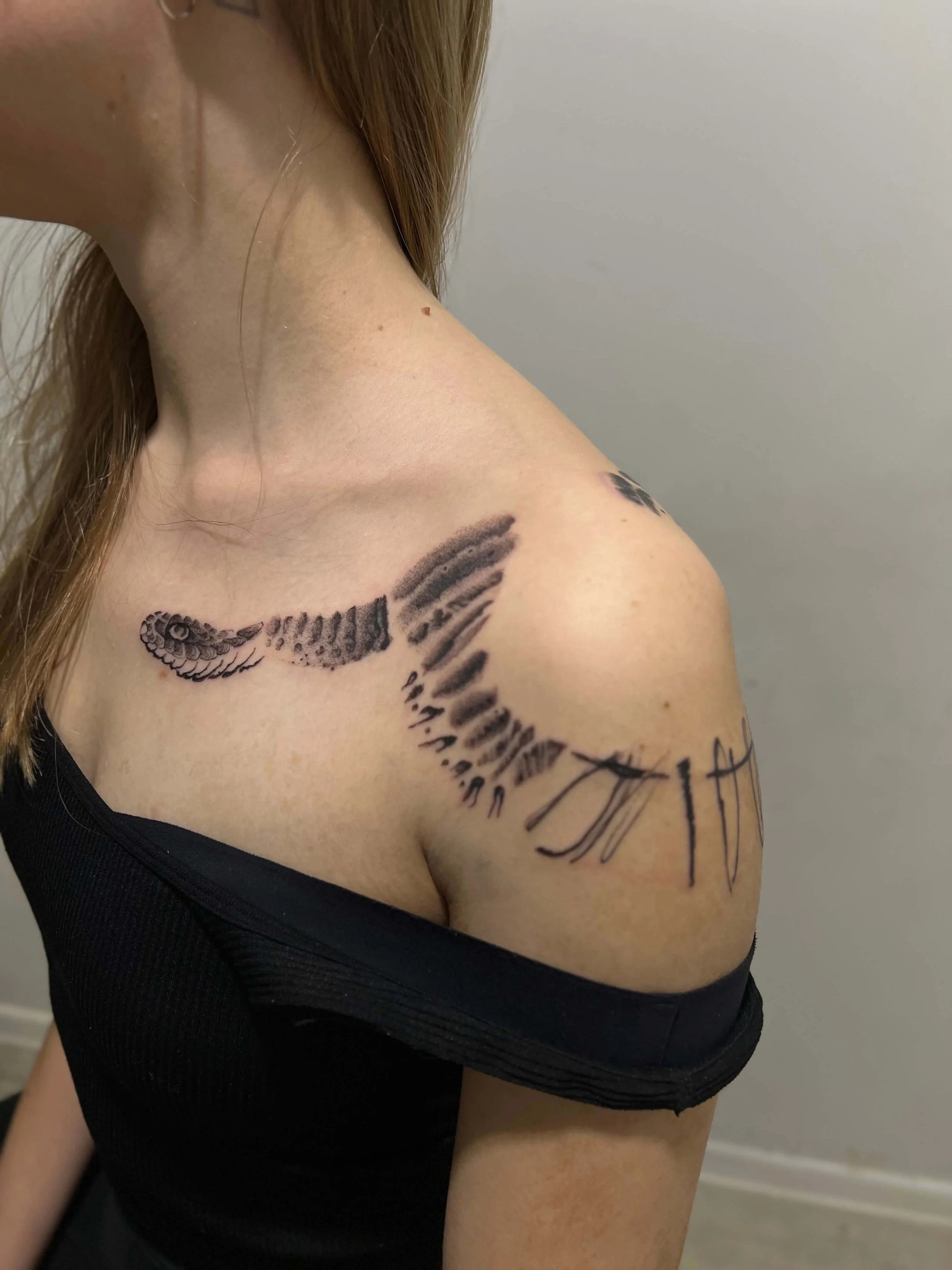 Contemporary blackwork tattoo featuring flowing abstract snake.