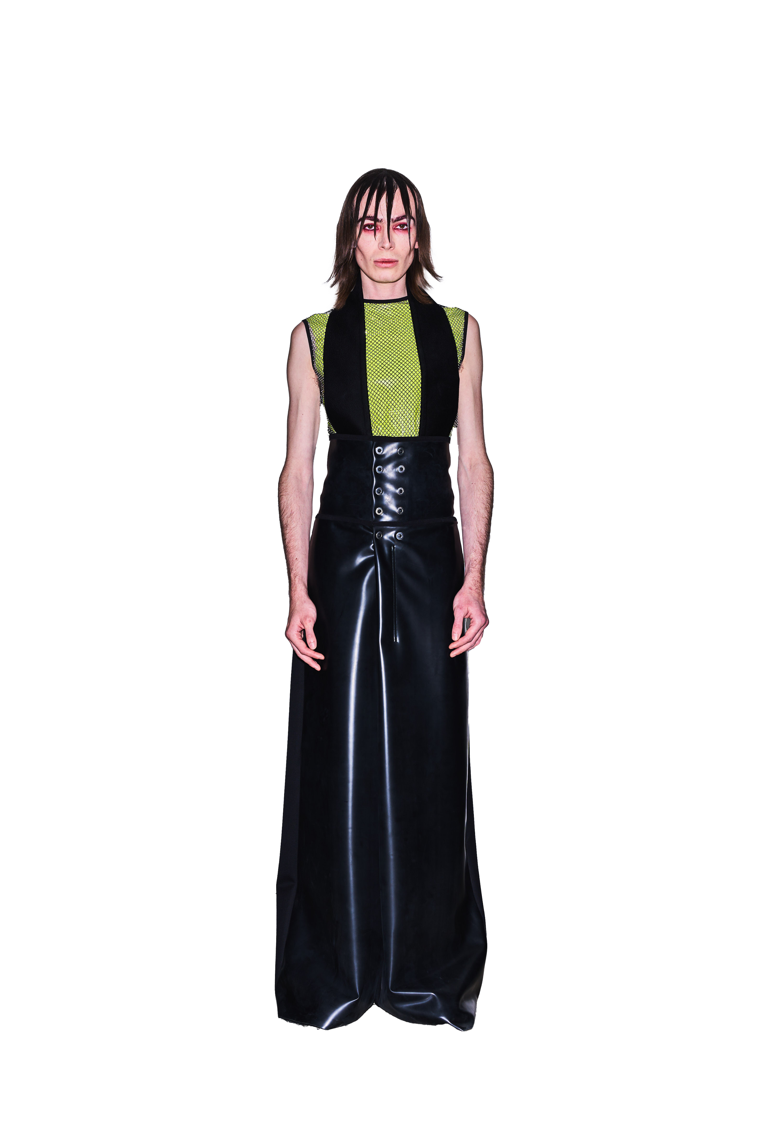 Person in a futuristic black and green outfit with a high-waisted skirt and sleeveless top on a white background.