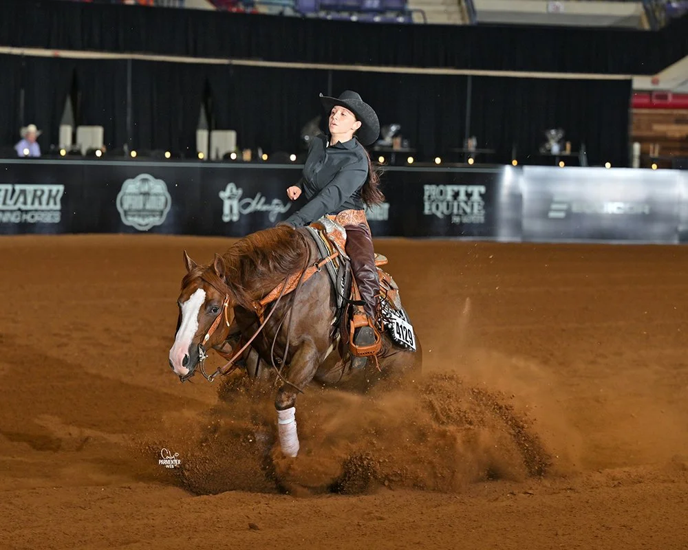 Daniela Picciotti on a horse performing a reining sliding stop