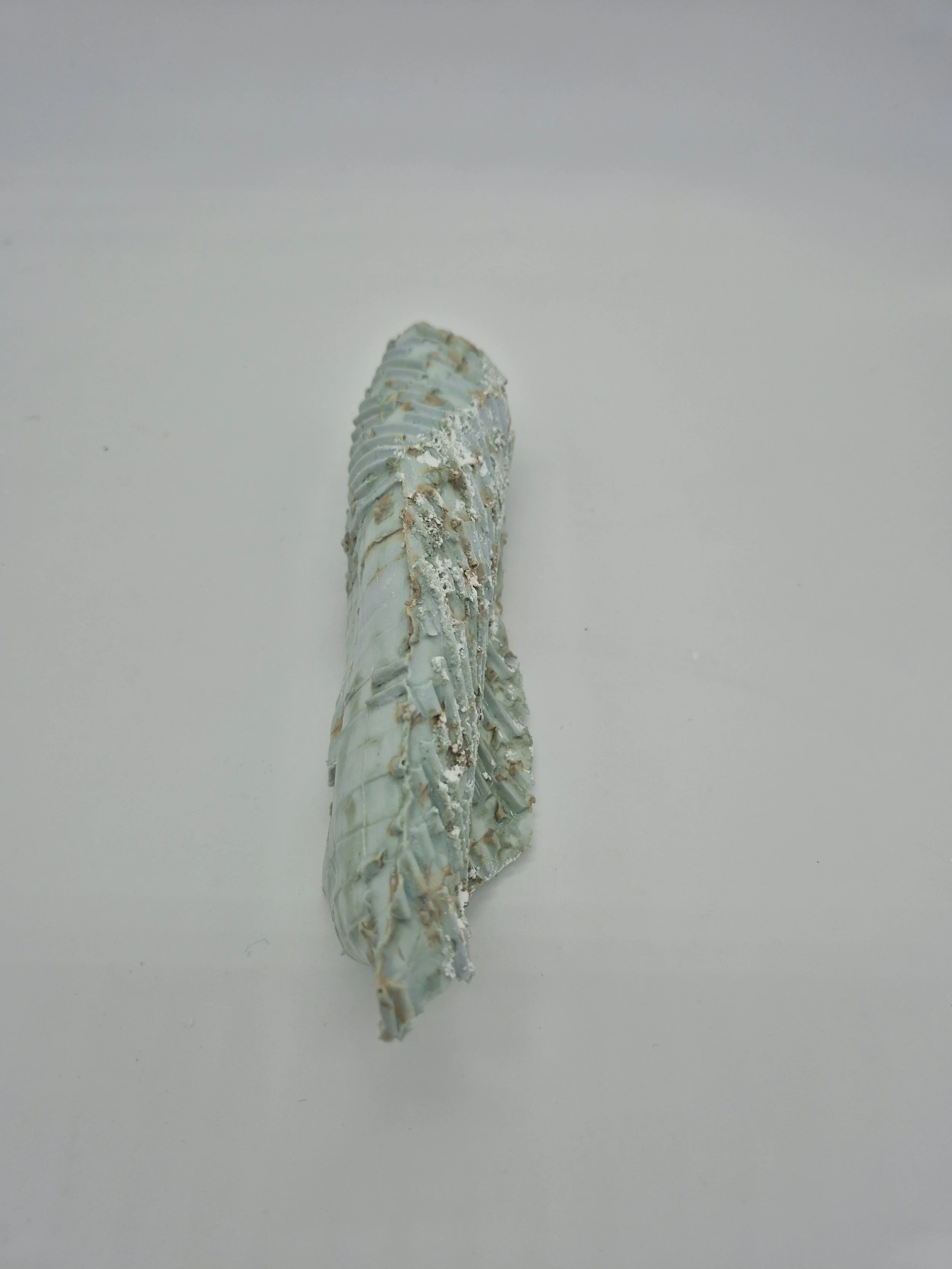 Een abstract kunstwerk met een geribbelde kopergroene textuur, gemaakt met karton