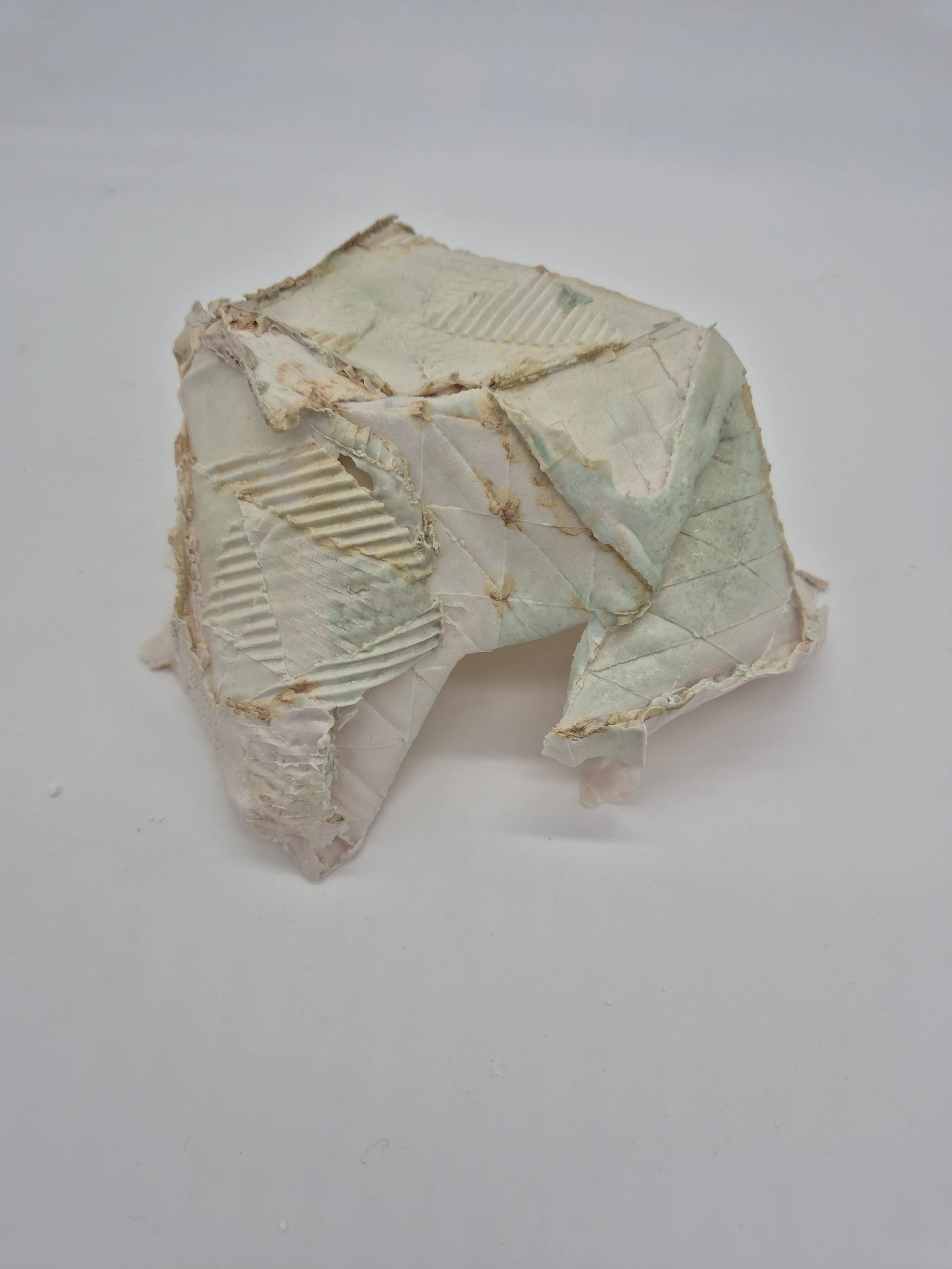 Keramiek gebaseerd op een papieren model met geometrische vormen en textuur op een witte achtergrond