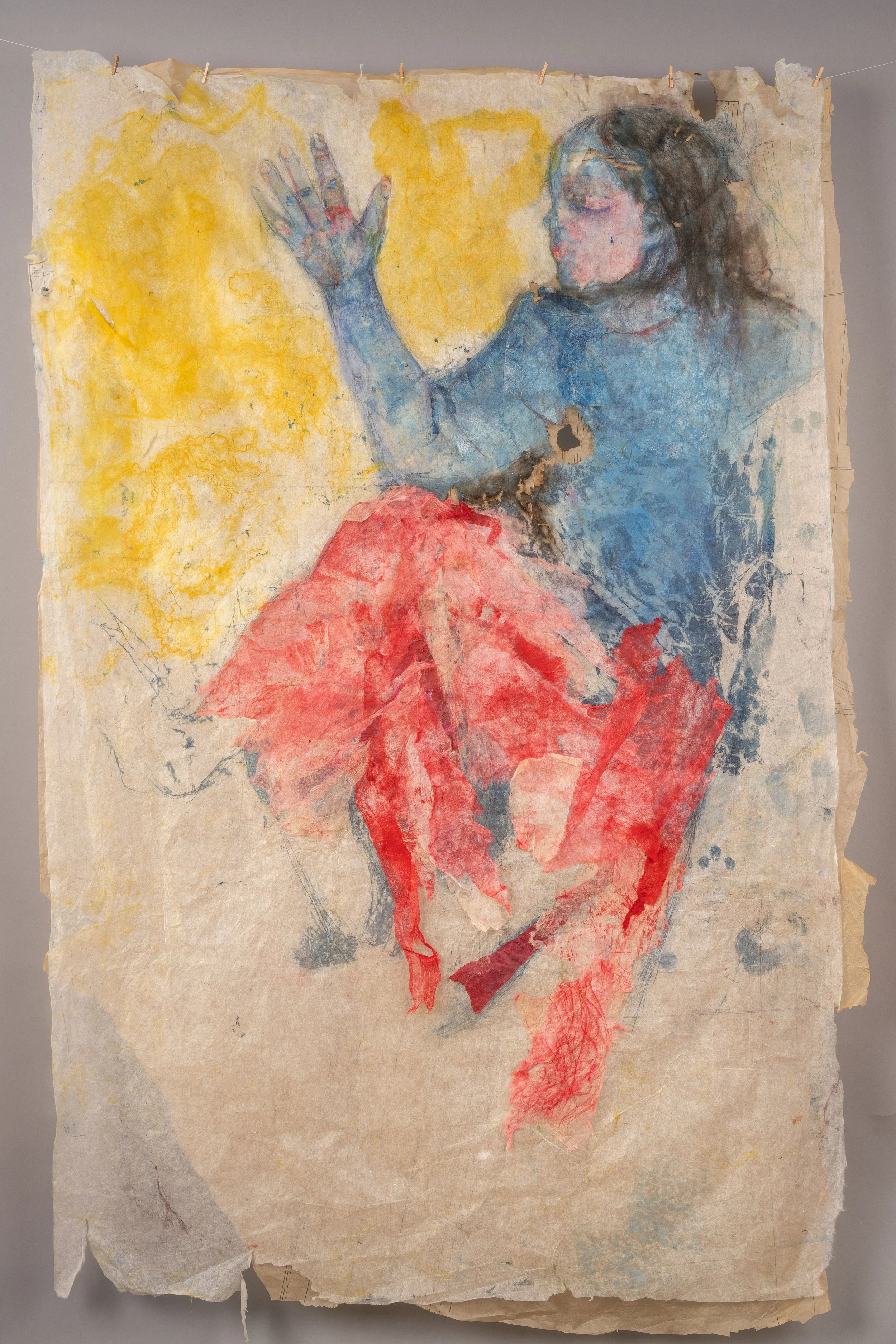 A large artwork on paper with a watercolor style portrait of a young girl with dark hair and closed eyes, wearing a blue top and a red skirt, with her hand raised against a yellow background.