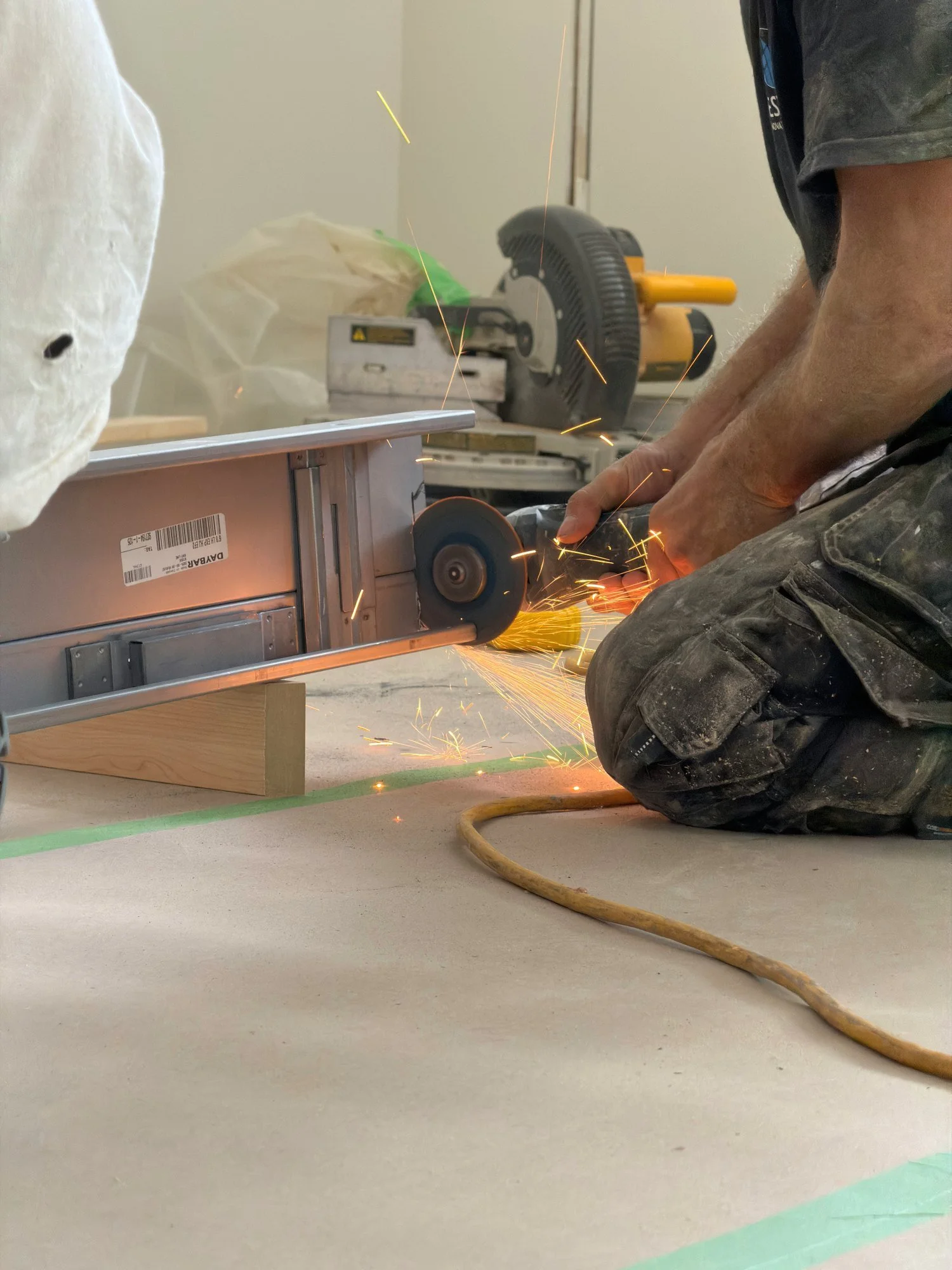 worker-cutting-wood-miter-saw-sparks-windsor-ontario-01.jpg