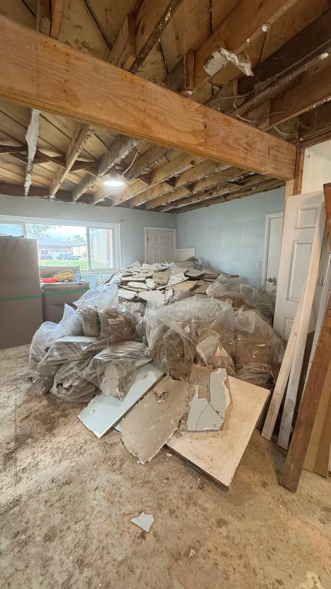 basement-demolition-debris-pile-exposed-joists-london-ontario-01.jpg