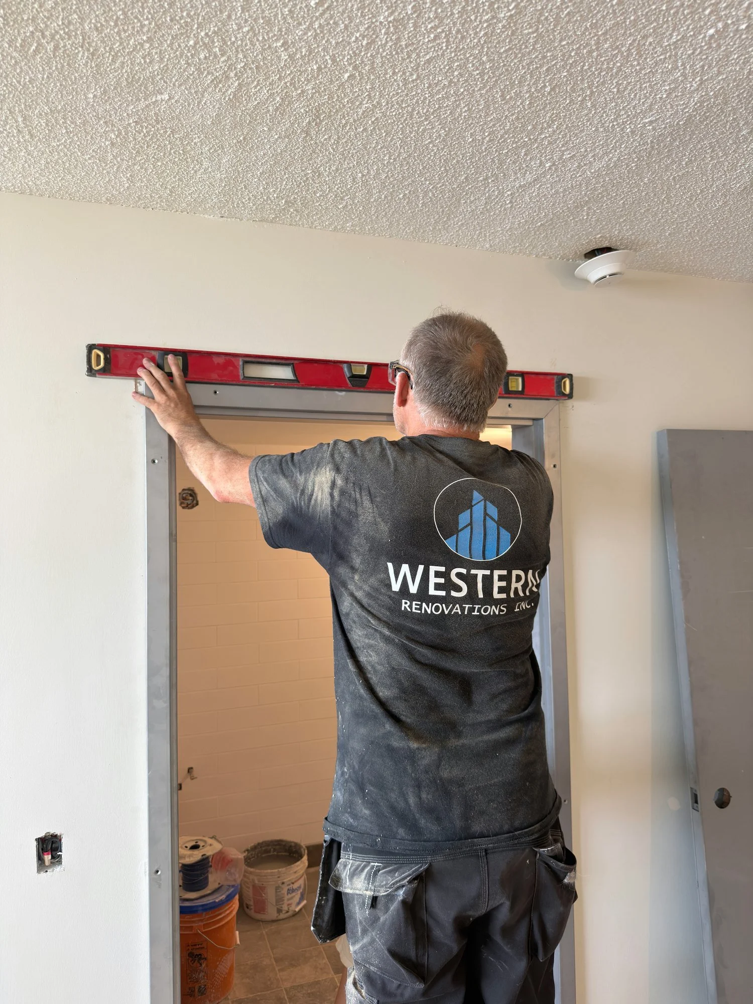 worker-leveling-door-frame-opening-windsor-ontario-01.jpg