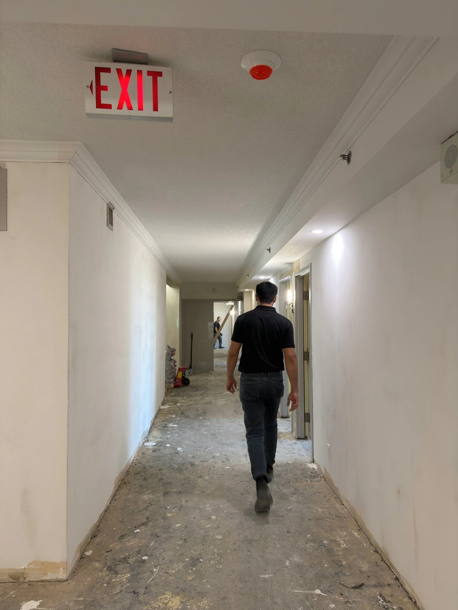 dusty-hallway-worker-exit-sign-debris-london-ontario-01.jpg
