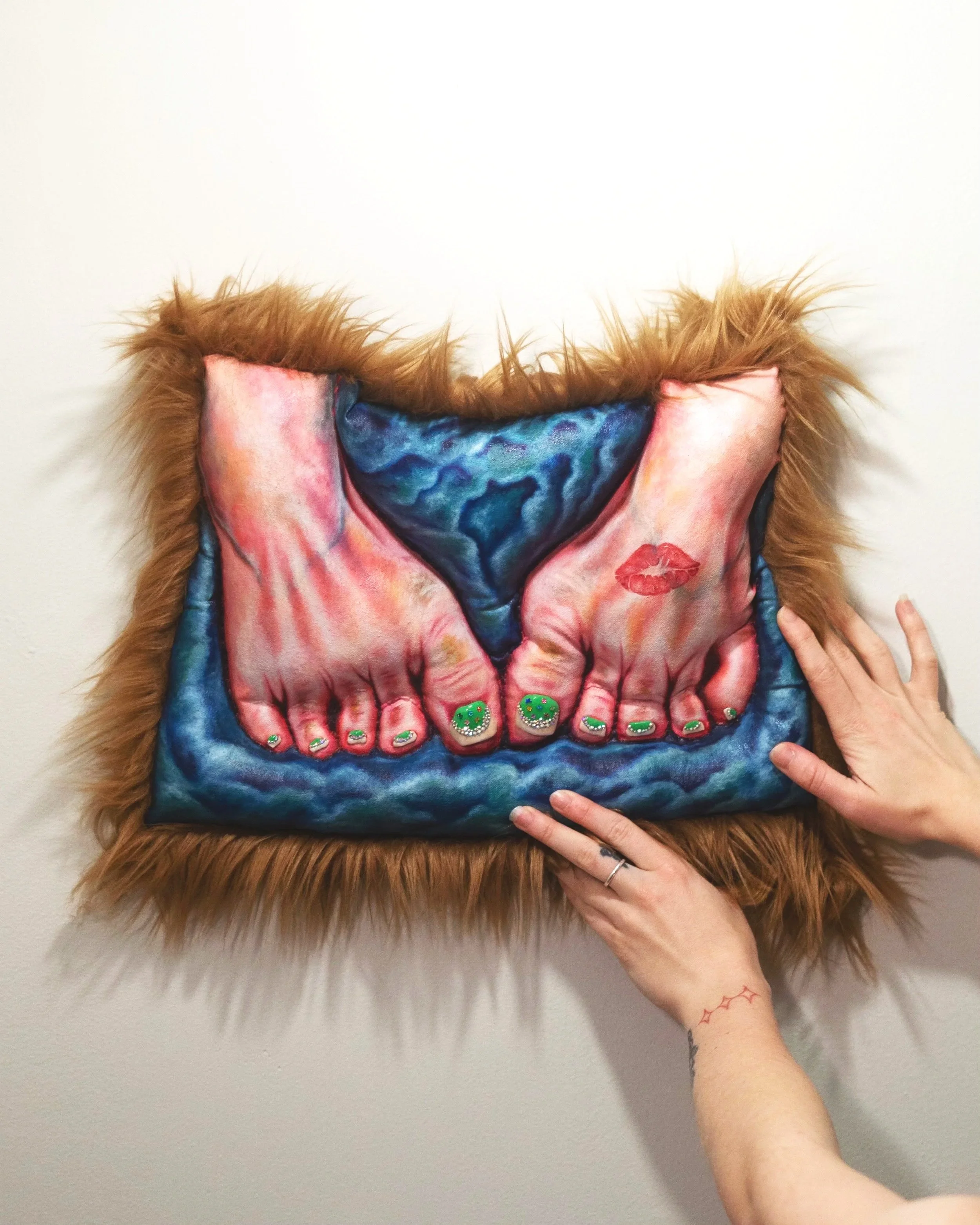 Emma Schwartz        
Kiss Her Feet, (Anointed), 2025                
Oil, canvas, embroidery thread, polyfil, modeling clay, nail polish, vegan fur, Swarovski crystals, rhinestones
10 x 15 x 2 in