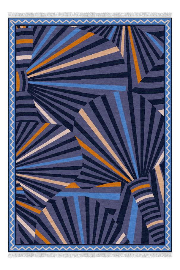 A rectangular rug with a geometric abstract pattern featuring navy blue, light blue, beige, and orange lines radiating outward across a dark background, bordered by a blue zigzag pattern.