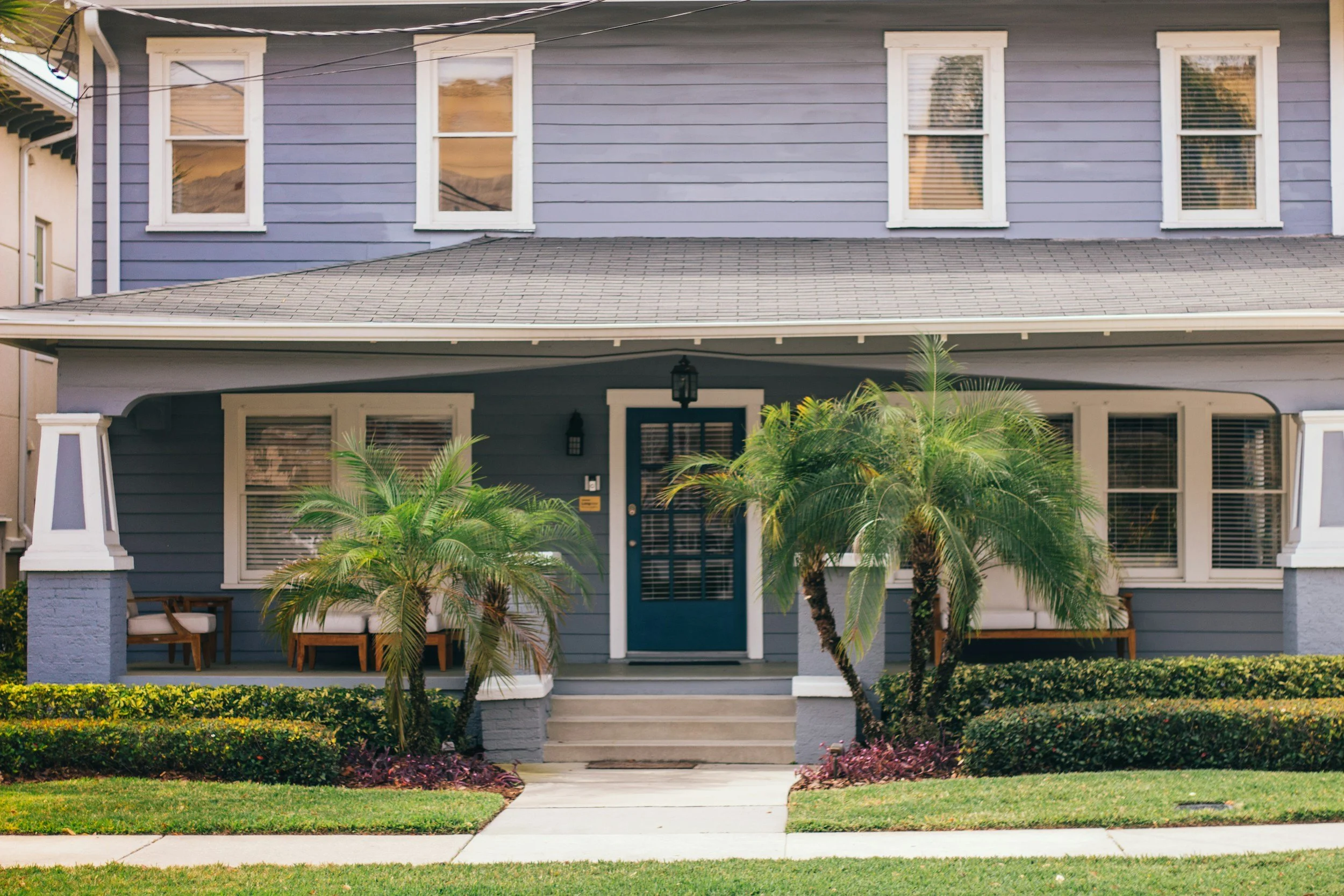 Tampa Bay home exterior with palm trees and a welcoming front porch