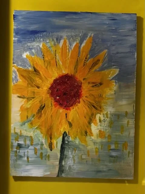 A painted sunflower with yellow petals and a red center against a gray and blue background.