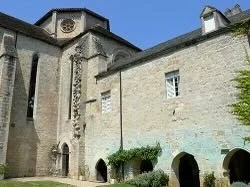 Historic stone church or cathedral with arched entrances and tall windows.