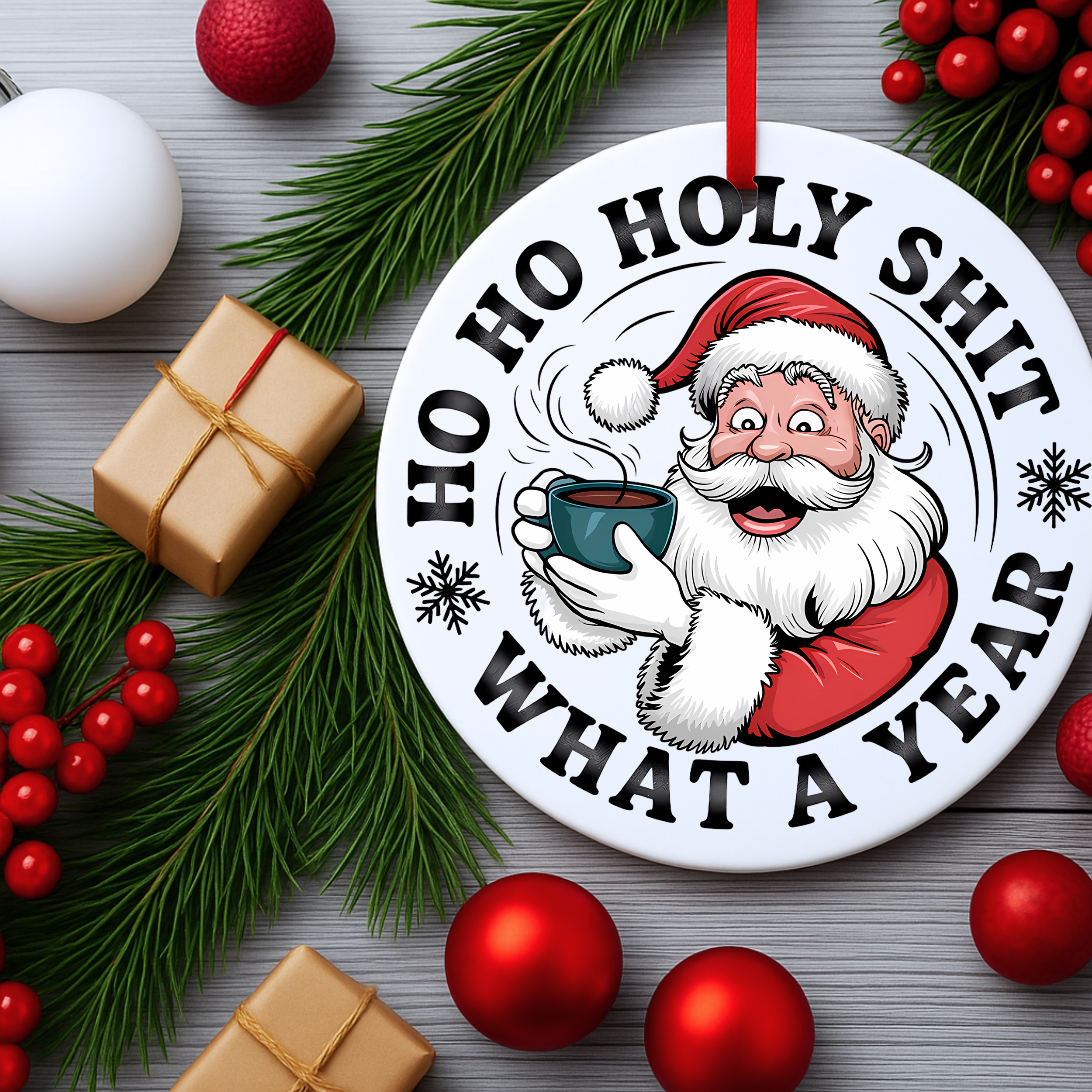 Funny Santa Christmas ornament flat lay surrounded by pine branches, red ornaments, and wrapped gifts.