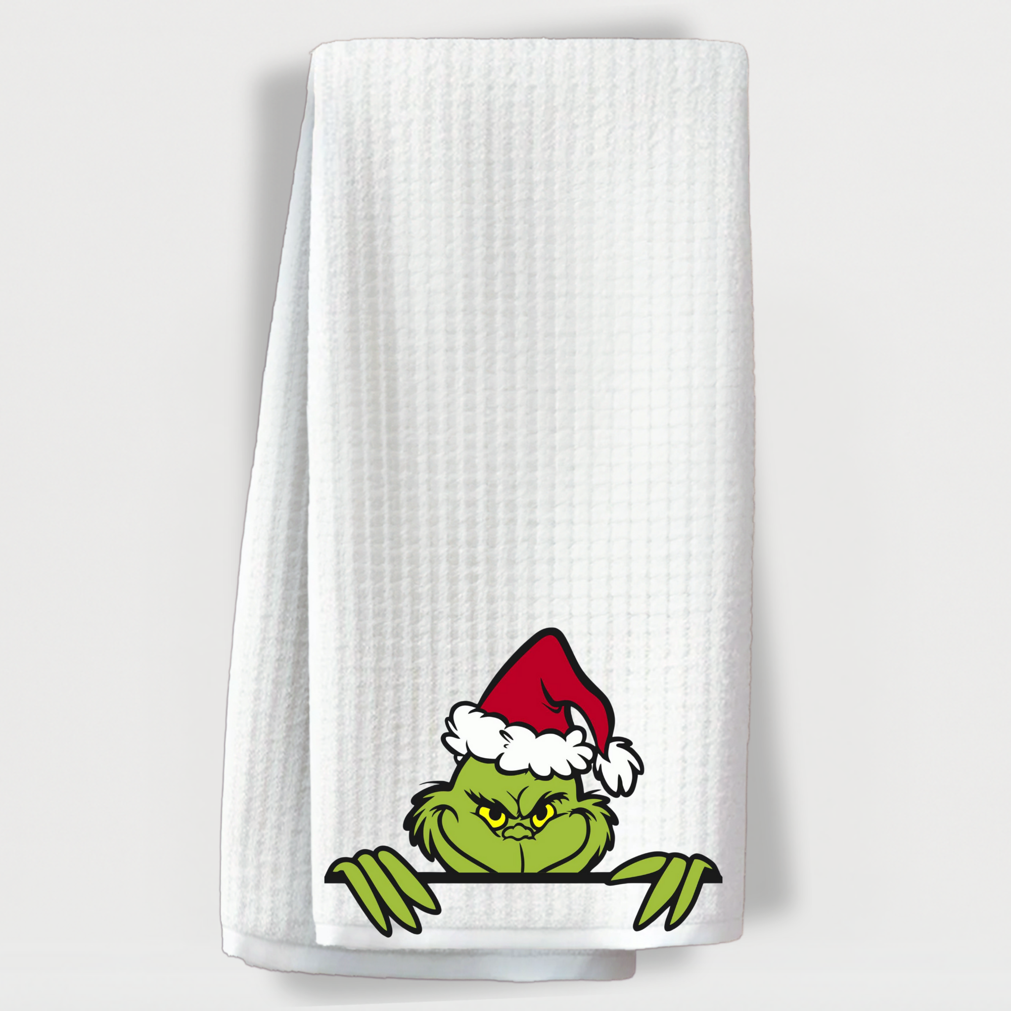 Funny Grinch-themed kitchen towel with Santa hat.
