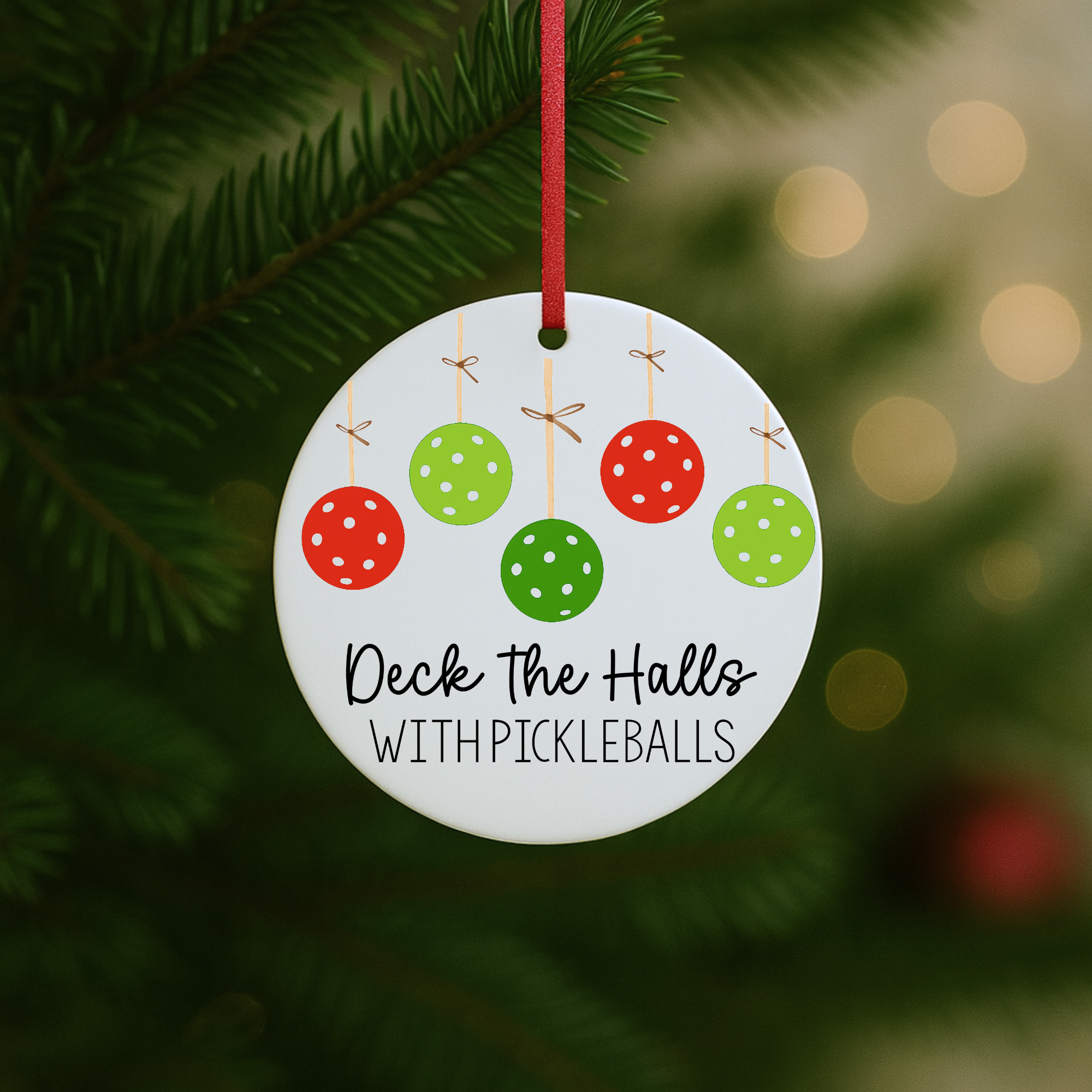 “Pickleball ornament hanging on a Christmas tree with red and green pickleball-themed baubles.”