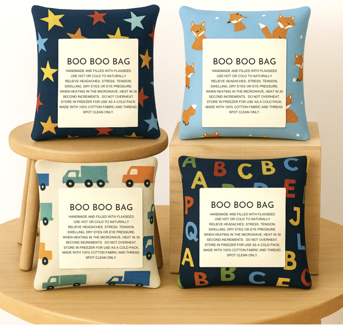 Set of four handmade flaxseed boo boo bags with fun kids' prints—stars, foxes, trucks, and ABC letters—displayed on wooden stools.