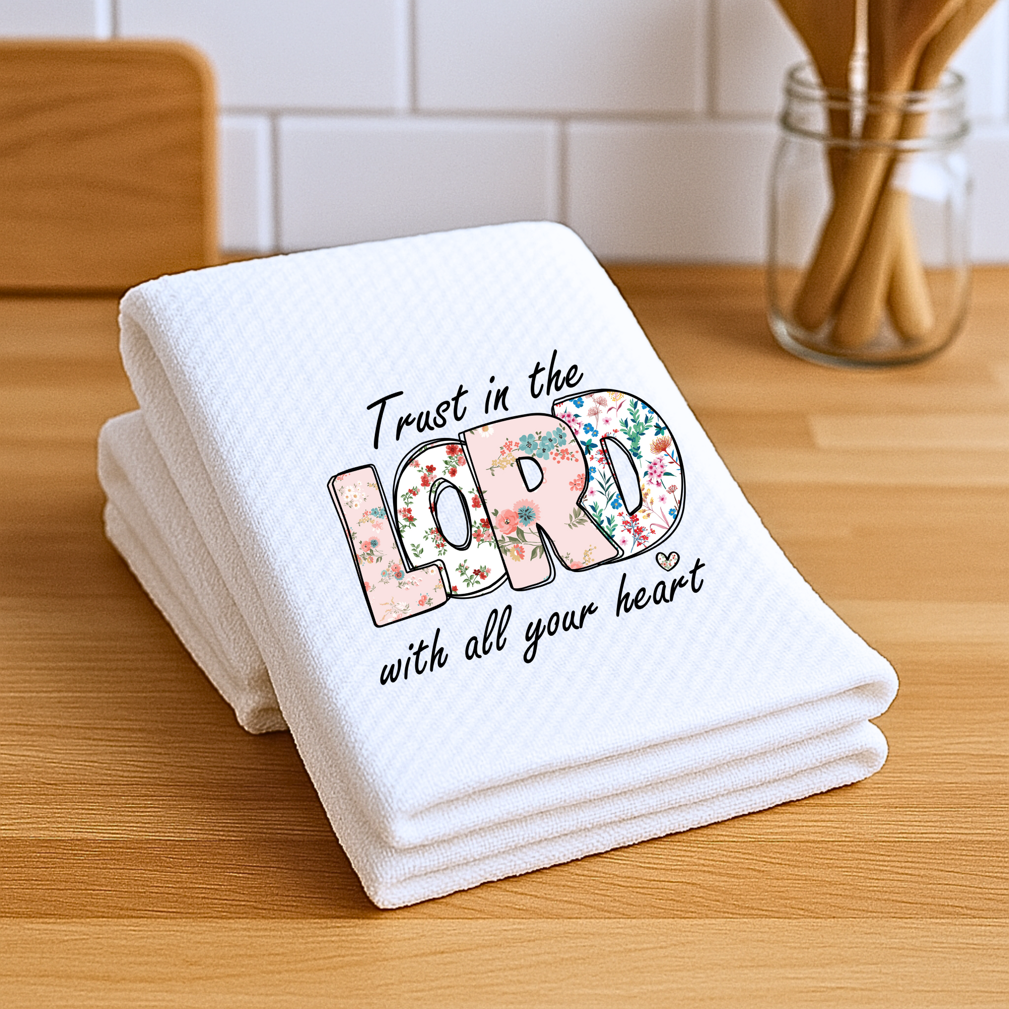 Waffle weave Christian hand towel folded with floral scripture design.