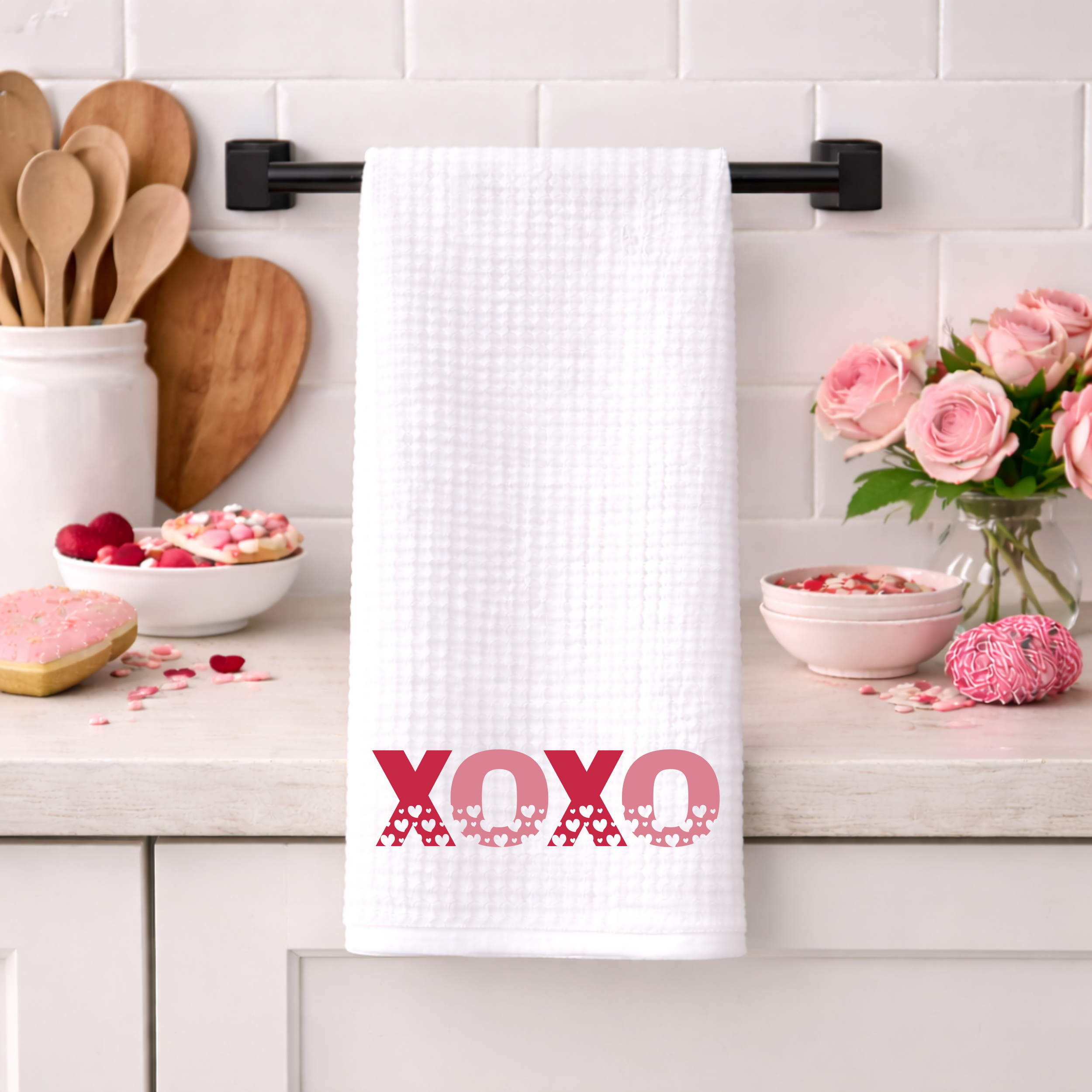 XOXO Valentine’s waffle weave kitchen towel hanging on black towel bar