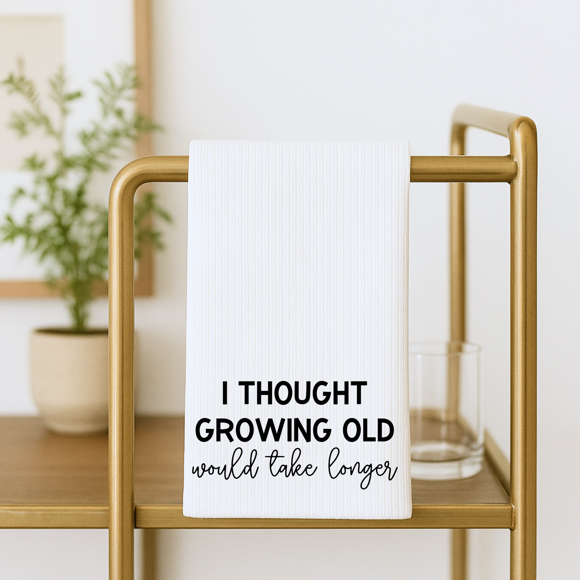 Modern farmhouse waffle weave towel with bold funny quote on display rack.