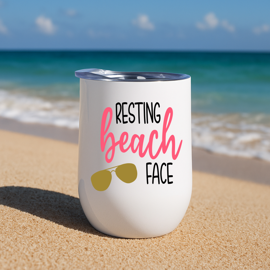 White wine tumbler on beach with “Resting Beach Face” design in watermelon pink and sunglasses graphic.