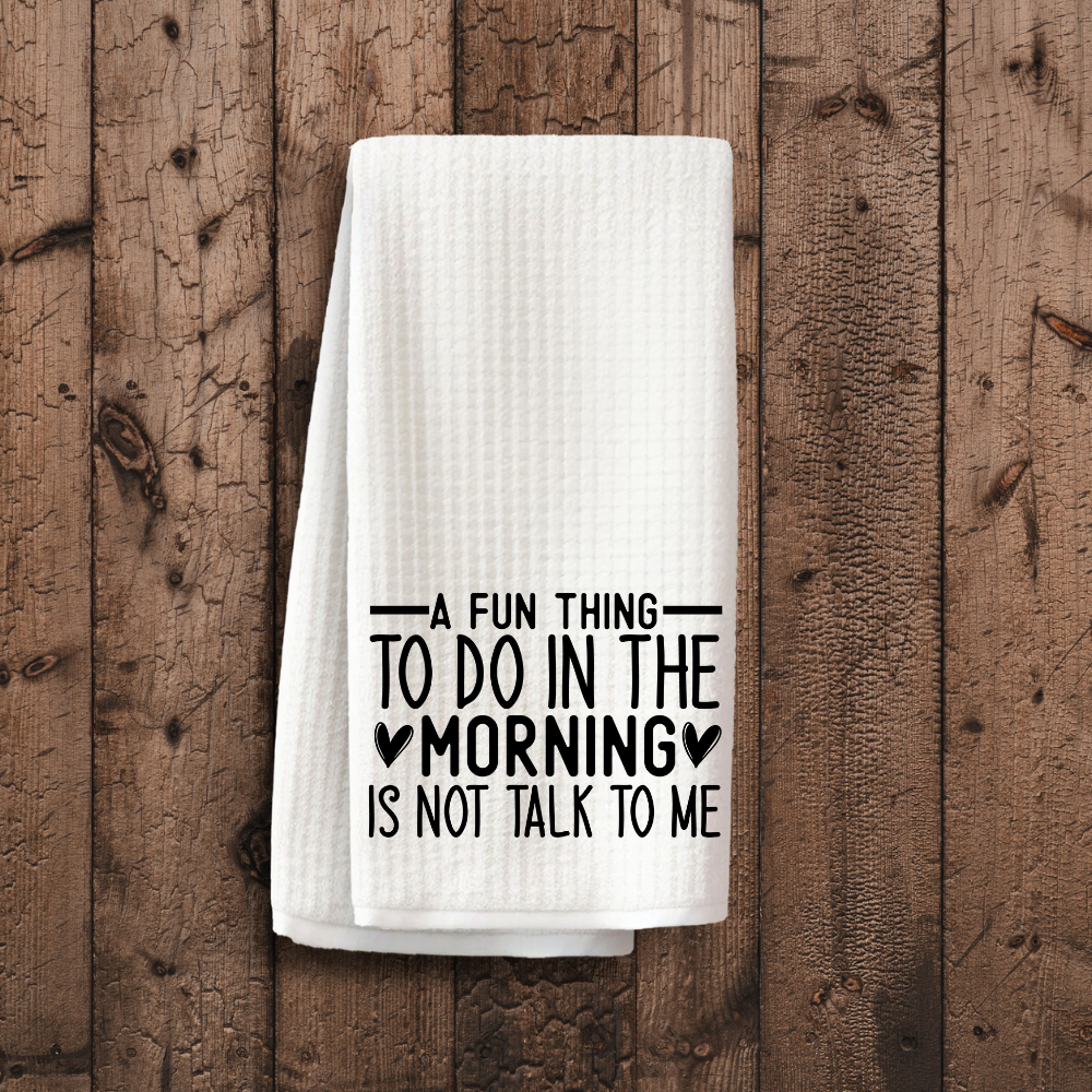Premium dish towel with a sarcastic morning quote displayed on a rustic wooden surface. Aesthetic and functional decor for coffee bars and kitchens.