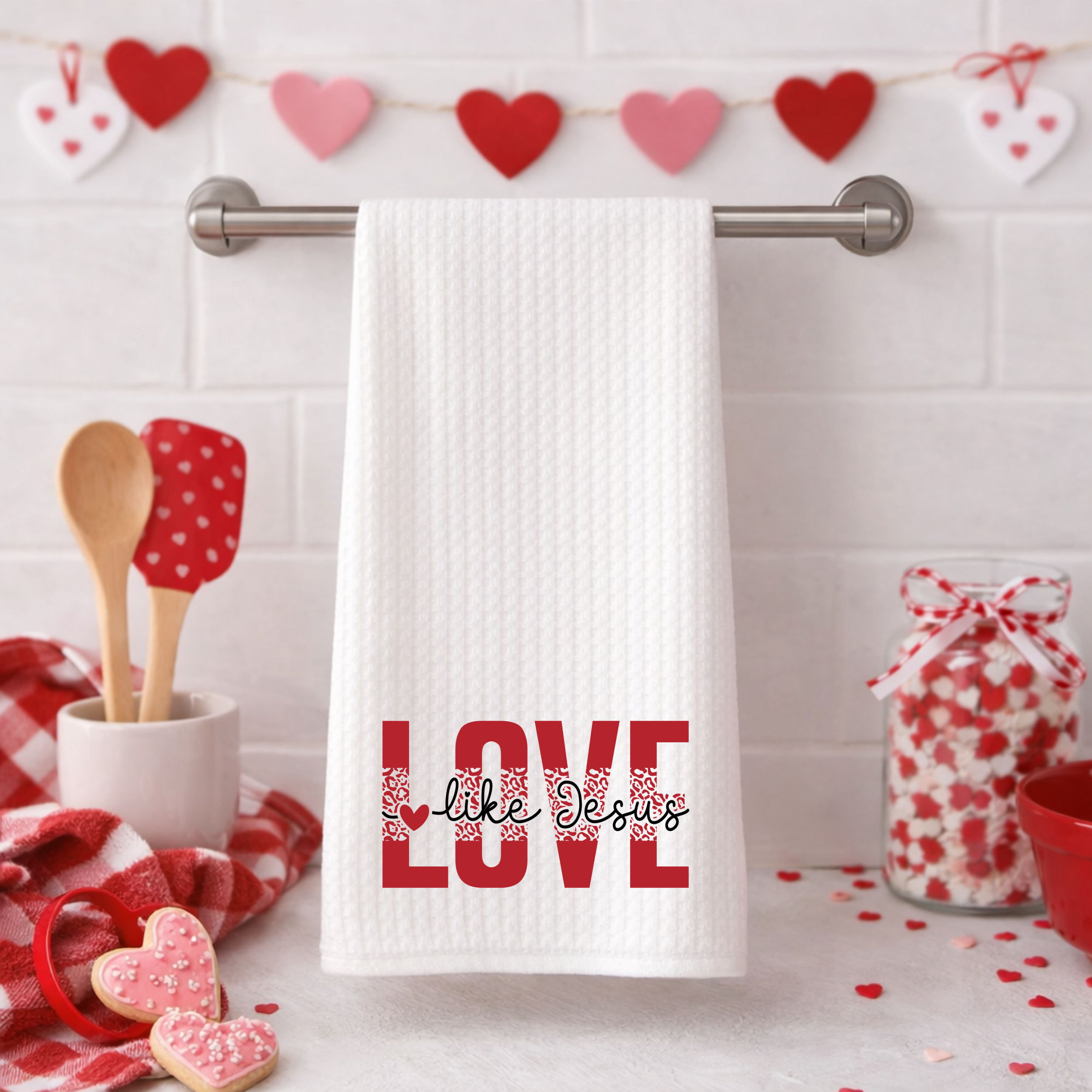 White waffle weave towel with red “Love Like Jesus” Christian message hanging on kitchen bar.