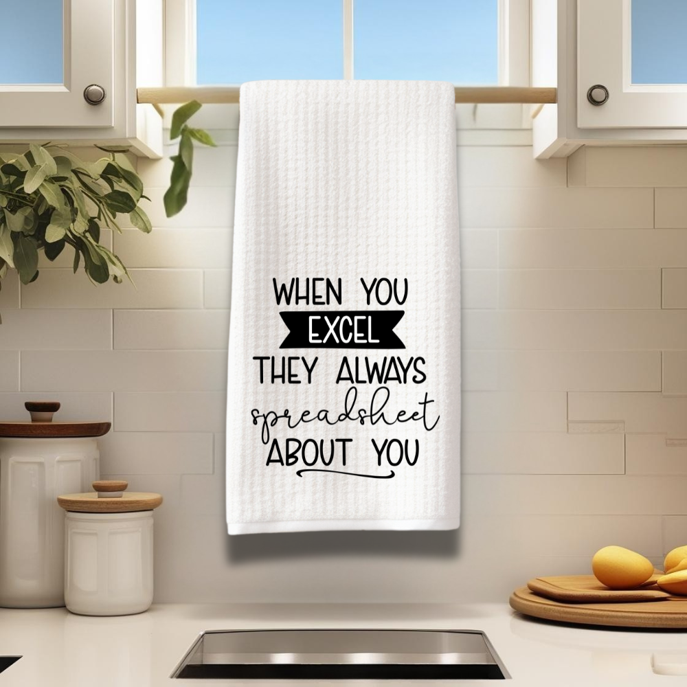 Humorous Excel kitchen towel displayed on a modern white kitchen towel rack.