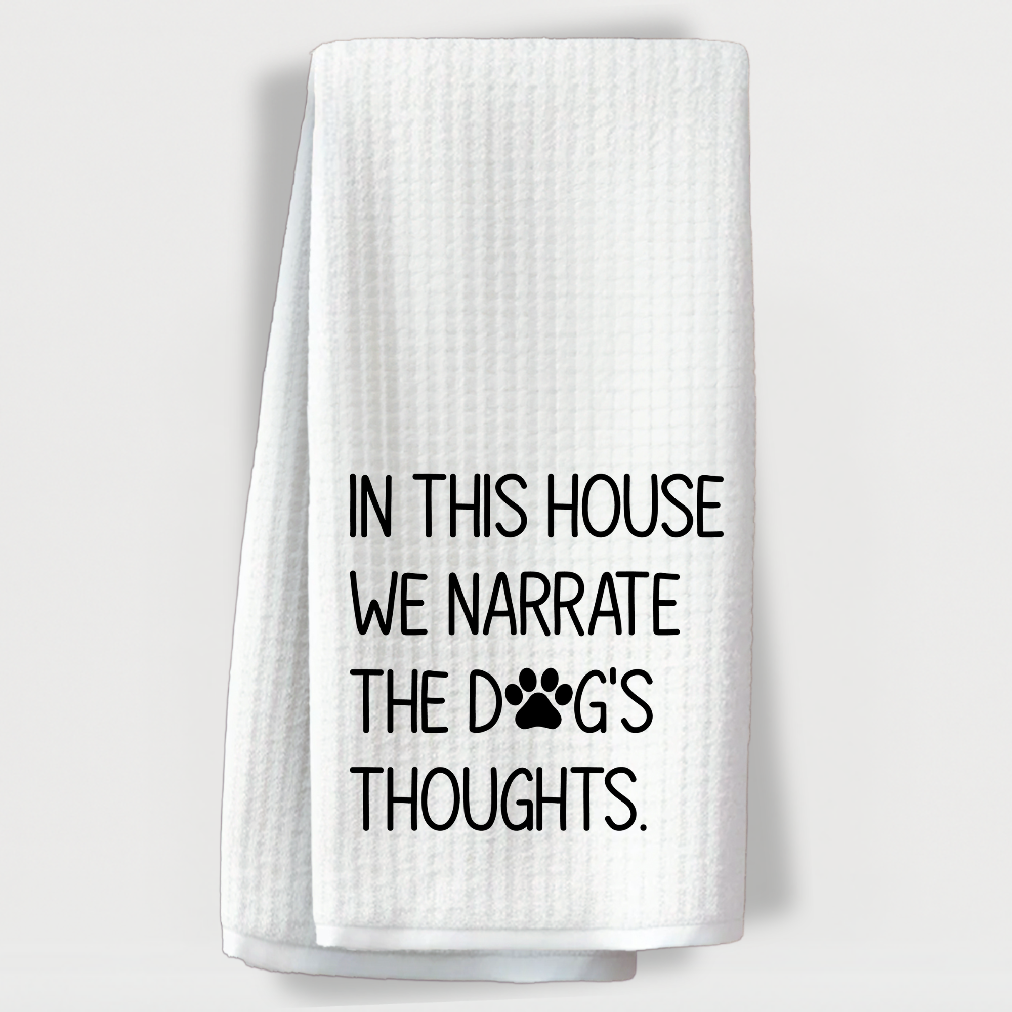 White waffle weave dish towel with the funny dog quote “In This House We Narrate the Dog’s Thoughts.”
