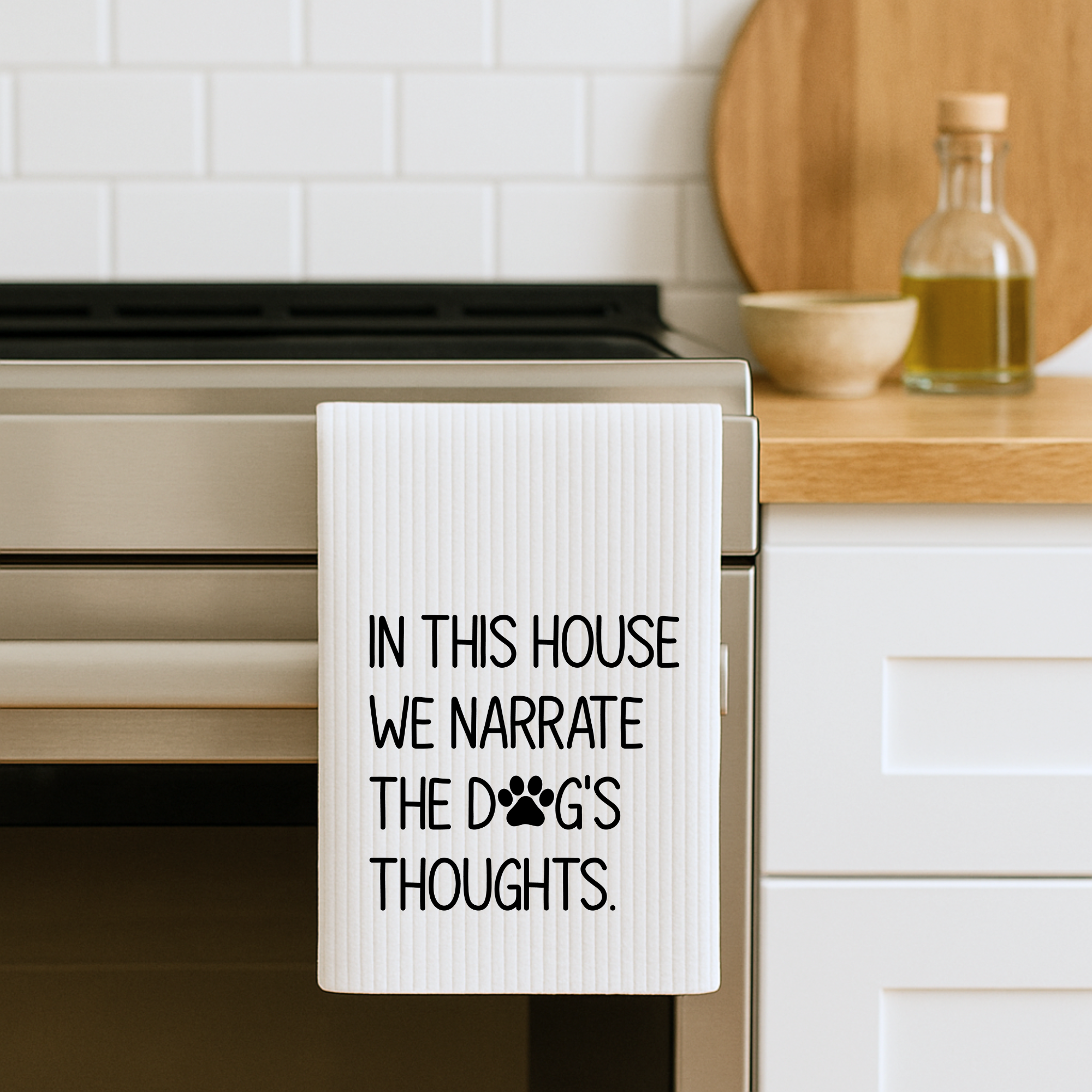 Waffle weave dog lover kitchen towel hanging on oven door, farmhouse kitchen decor style.