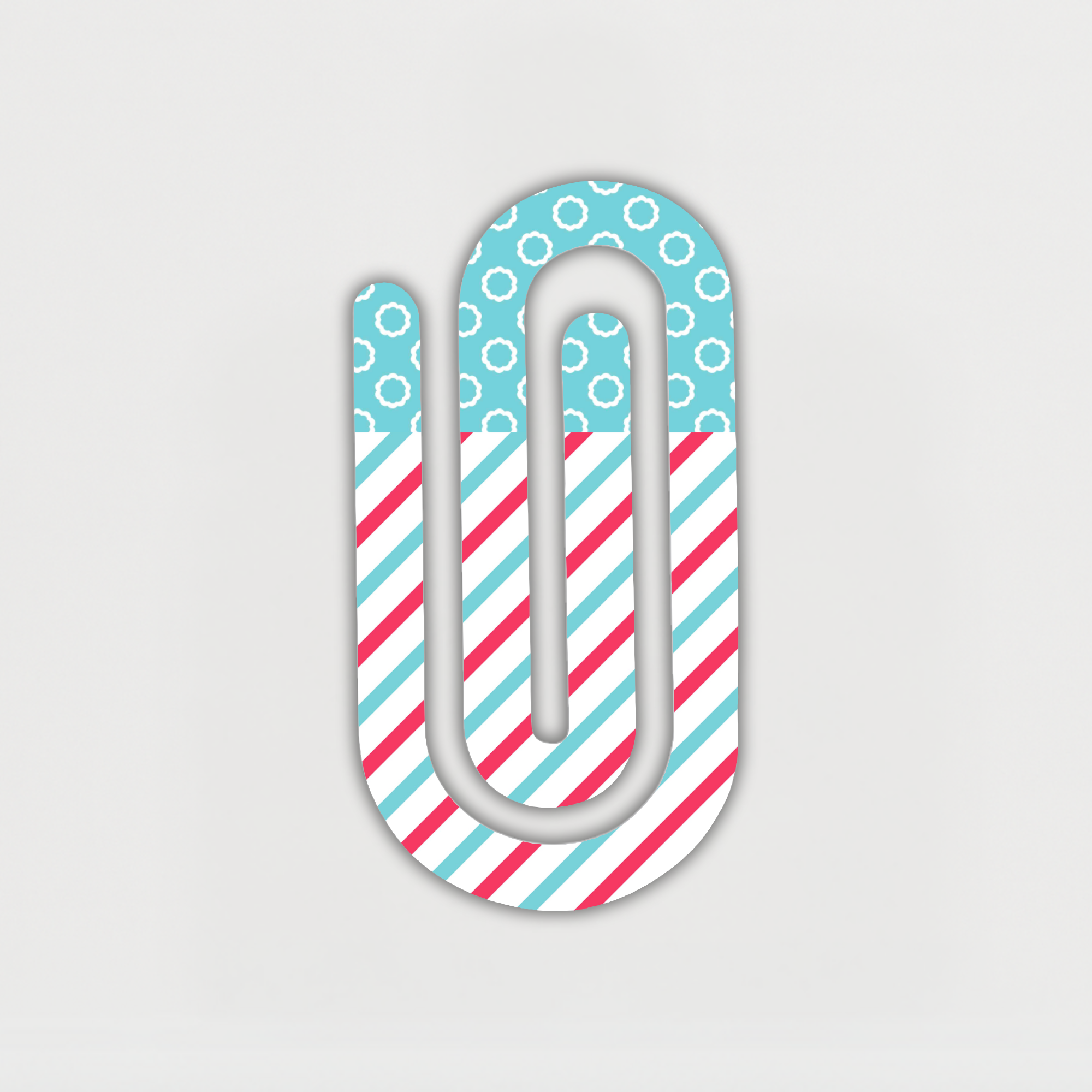 Jumbo acrylic paper clip with red and aqua striped pattern on white background.