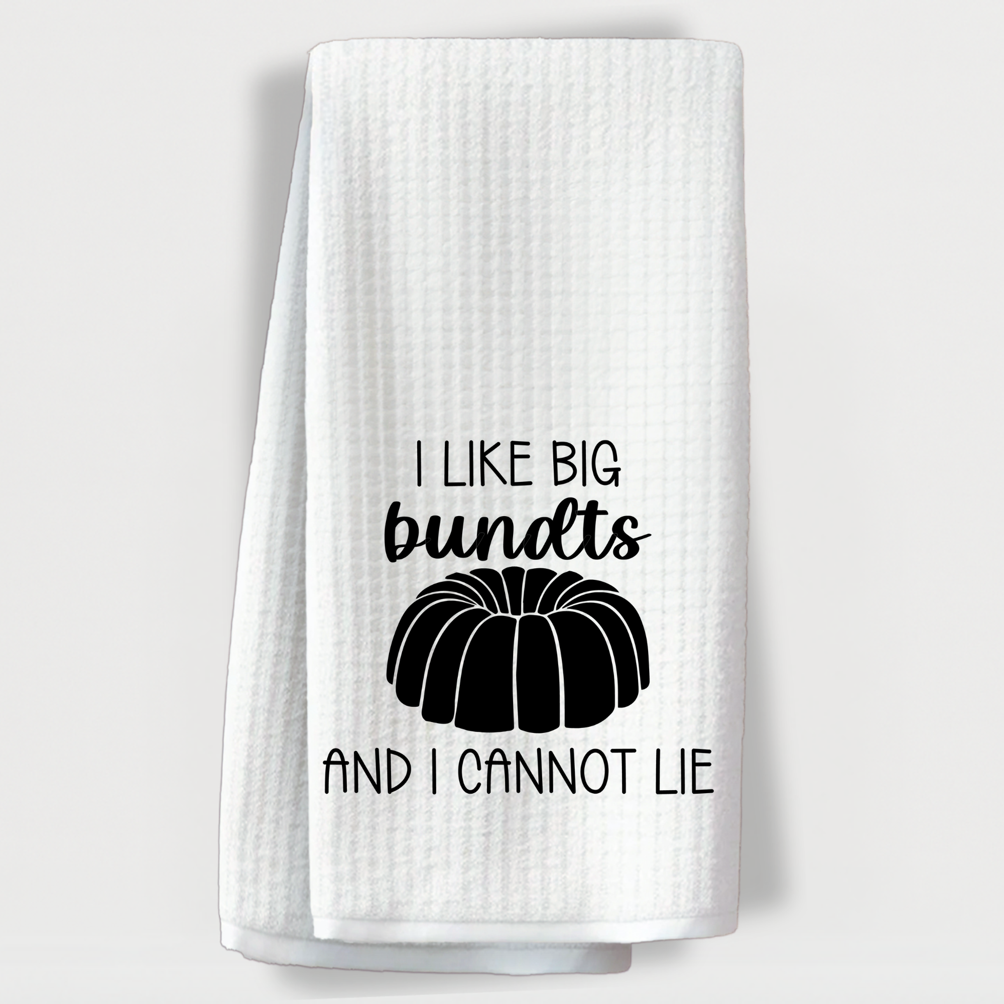 Baking humor dish towel with the phrase 'I like big bundts and I cannot lie' and bundt cake image.