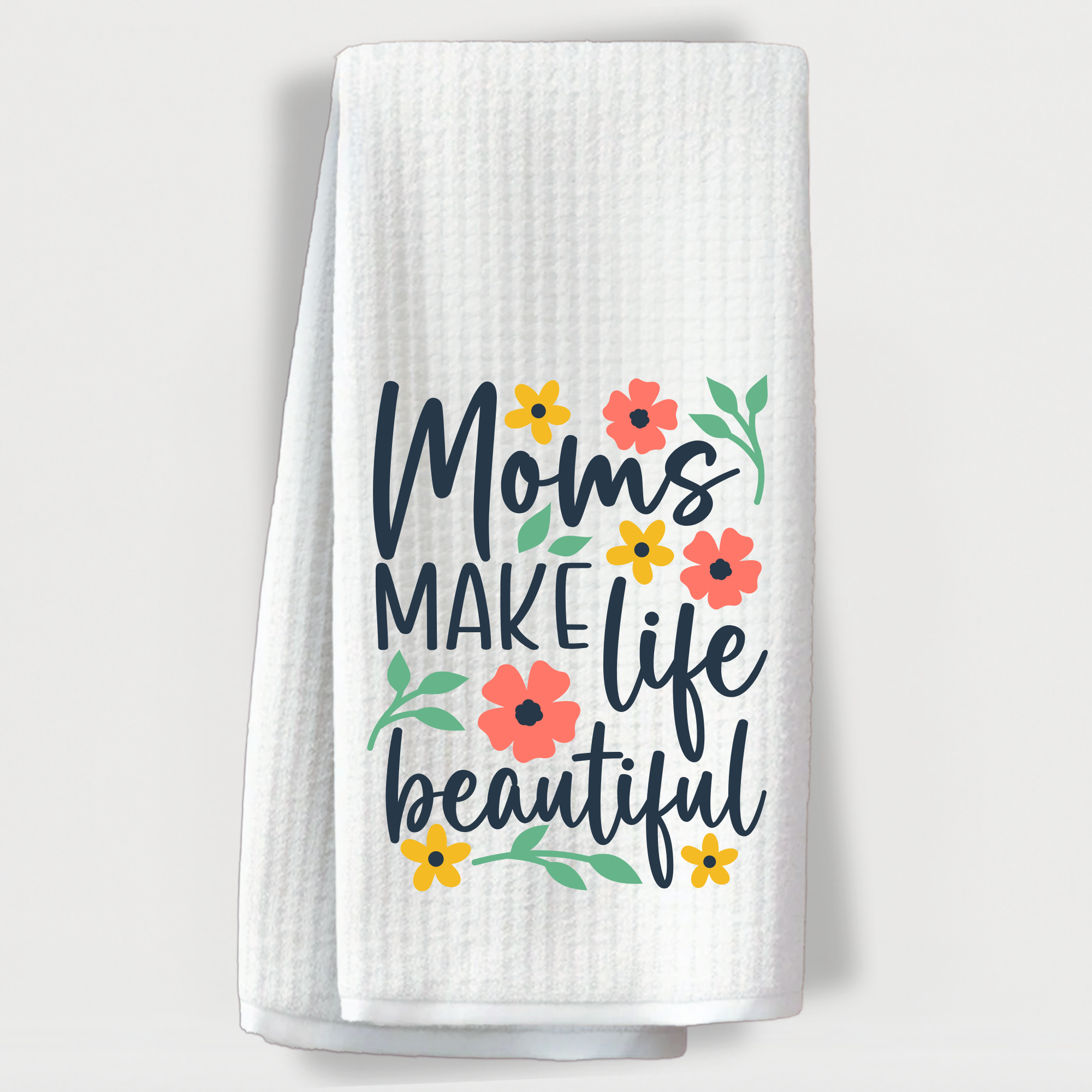 "Colorful floral towel with the heartfelt quote 'Moms make life beautiful' in blue and pink design."