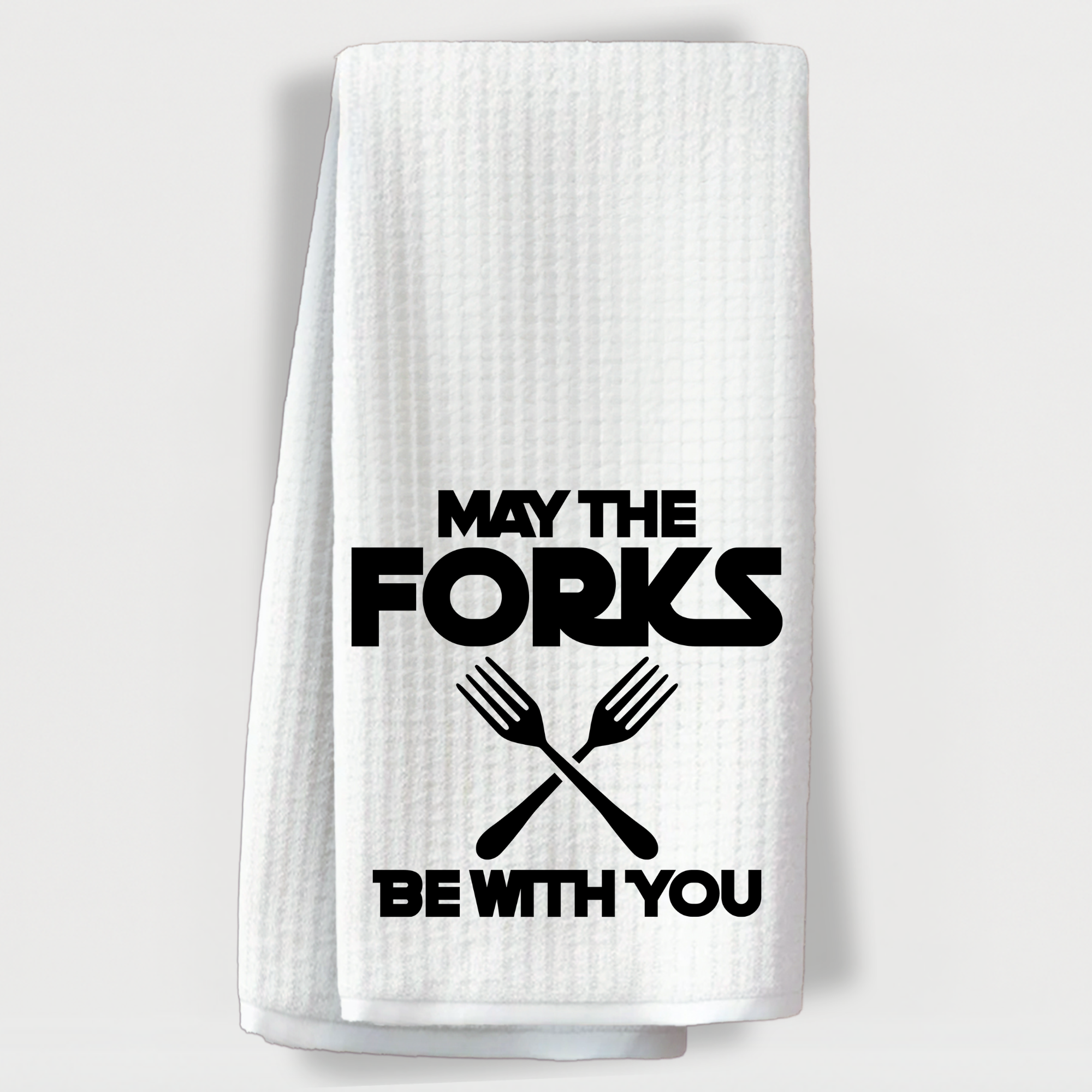 "Witty Star Wars-inspired towel that says 'May the forks be with you' with crossed fork graphics."