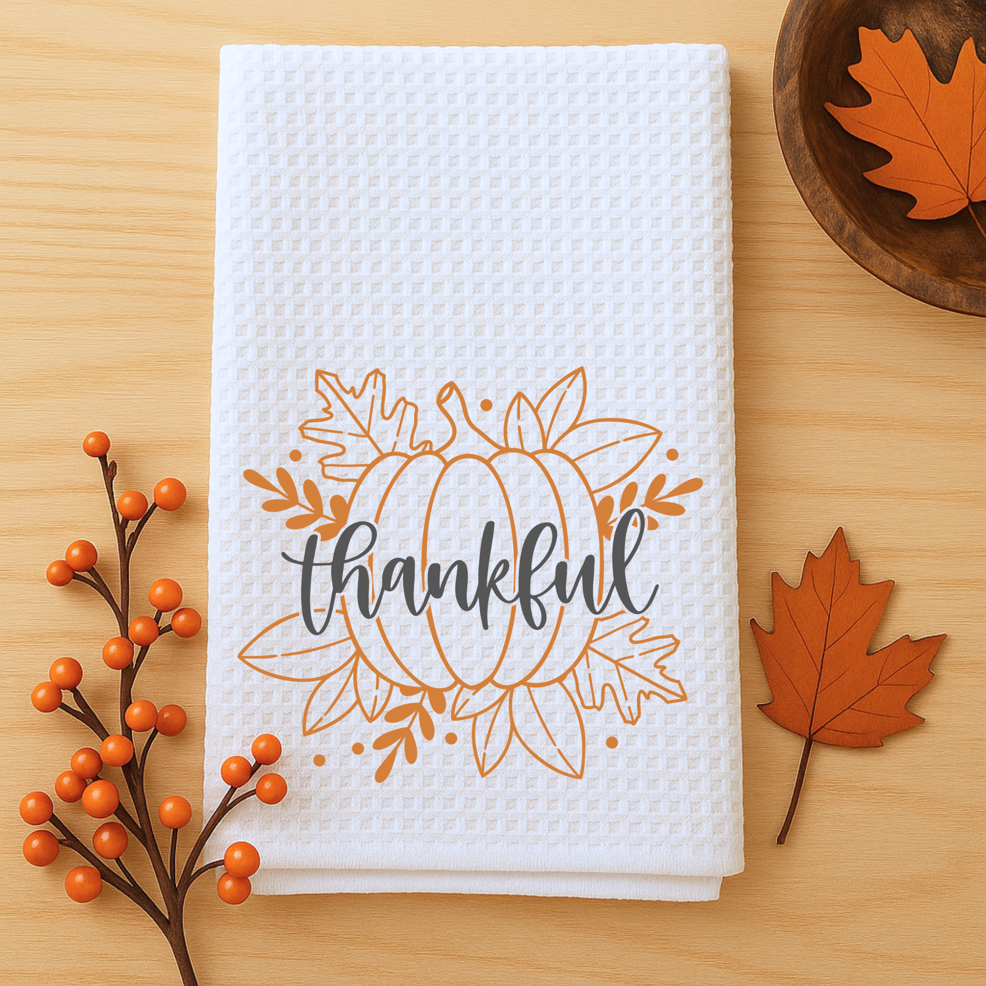Farmhouse fall kitchen towel with pumpkin and autumn leaf design, waffle weave texture.