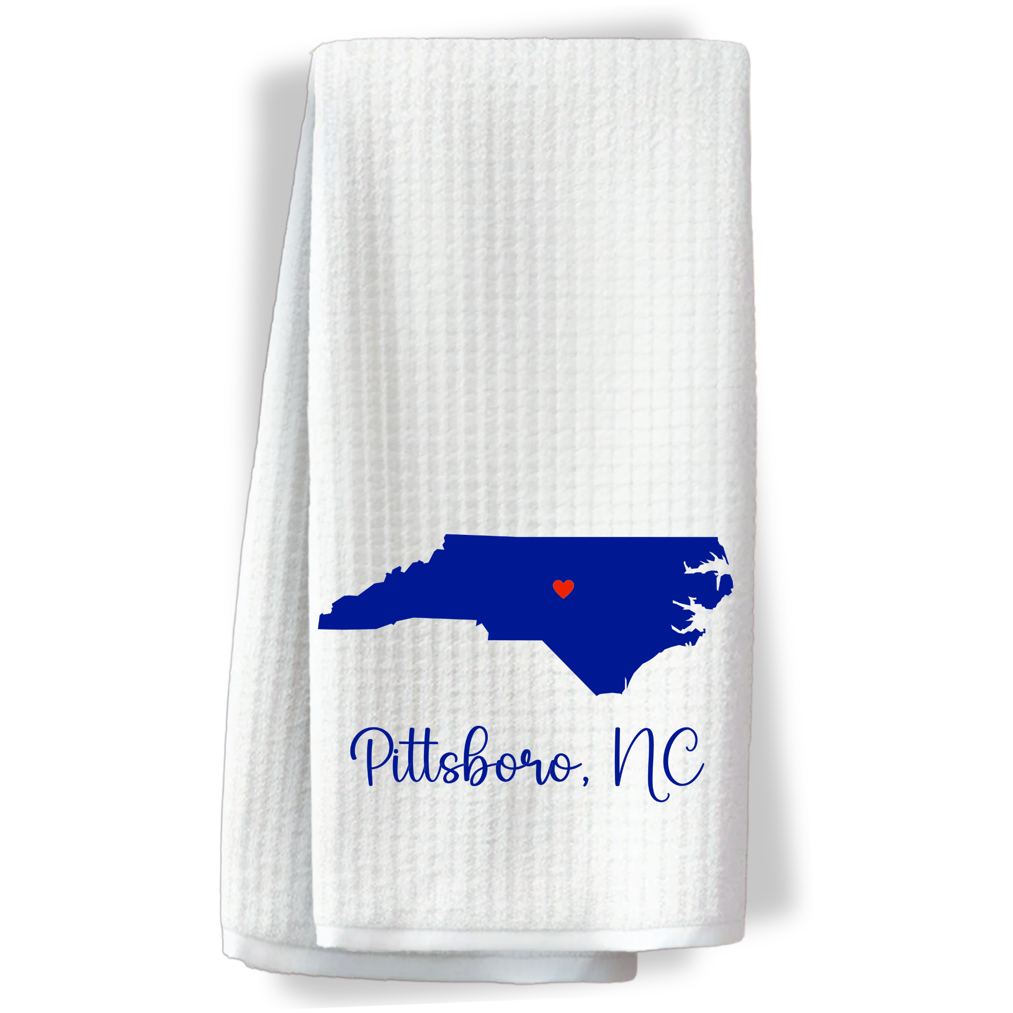 "Kitchen towel with a dark blue North Carolina map and red heart highlighting Pittsboro, NC."