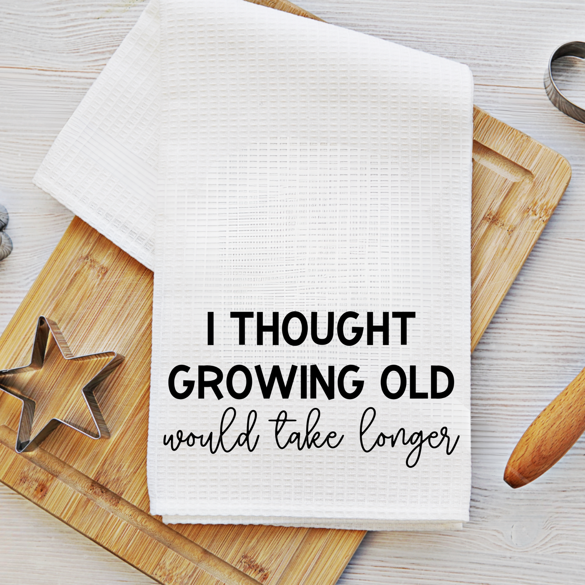 Funny sublimation waffle weave towel with growing old quote displayed with baking tools.