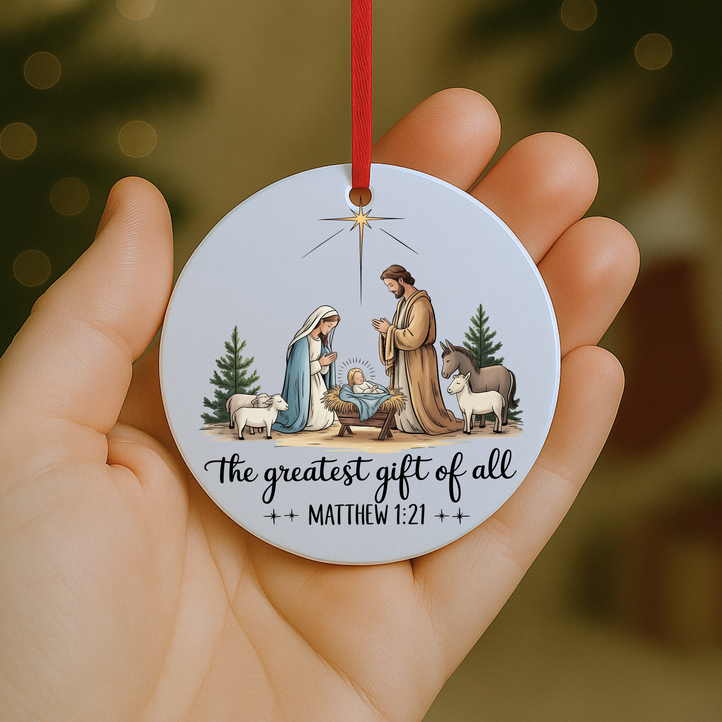 Christian nativity Christmas ornament featuring Mary, Joseph, and baby Jesus with the phrase “The greatest gift of all” Matthew 1:21.