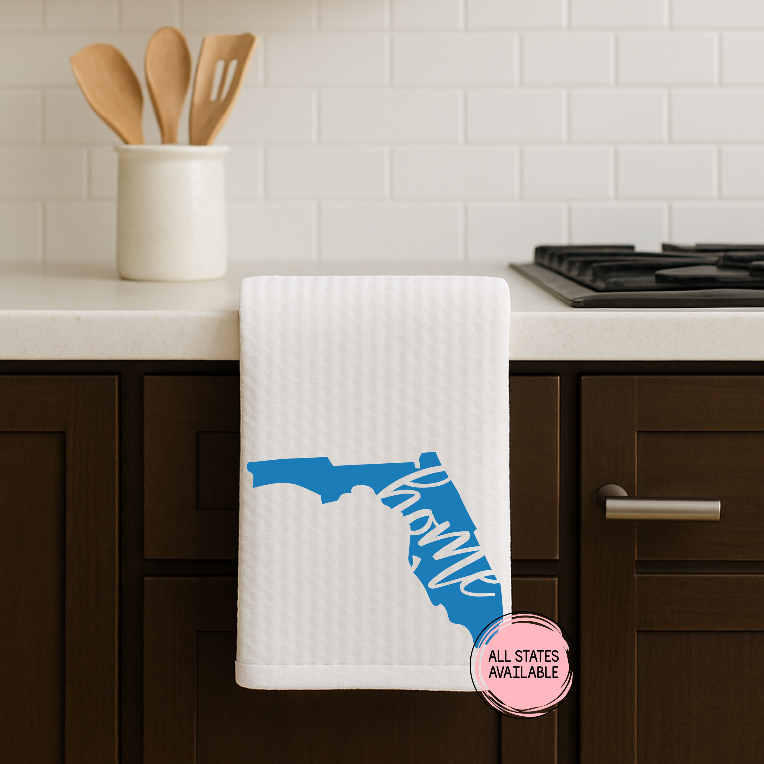 Florida home state waffle weave kitchen towel in blue hanging on a dark cabinet in a contemporary kitchen.
