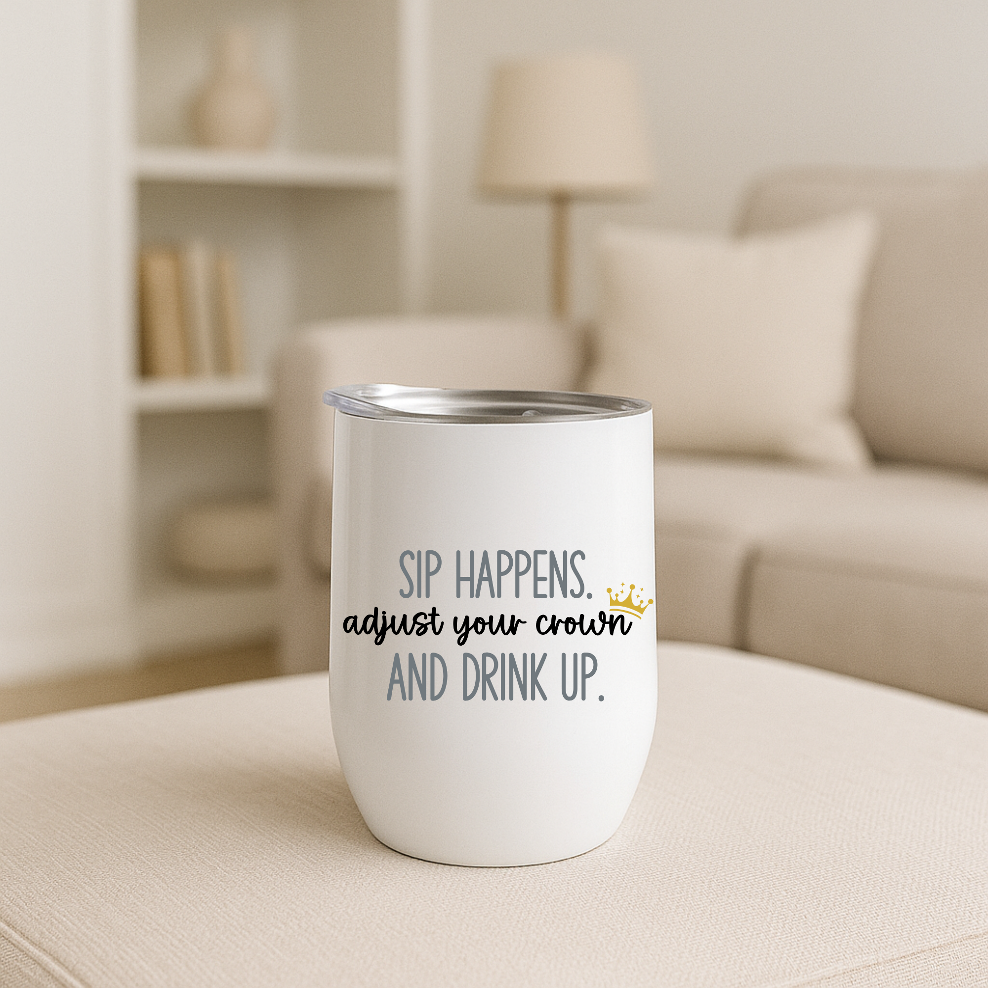 Sip Happens wine tumbler with gray text, neutral living room decor.