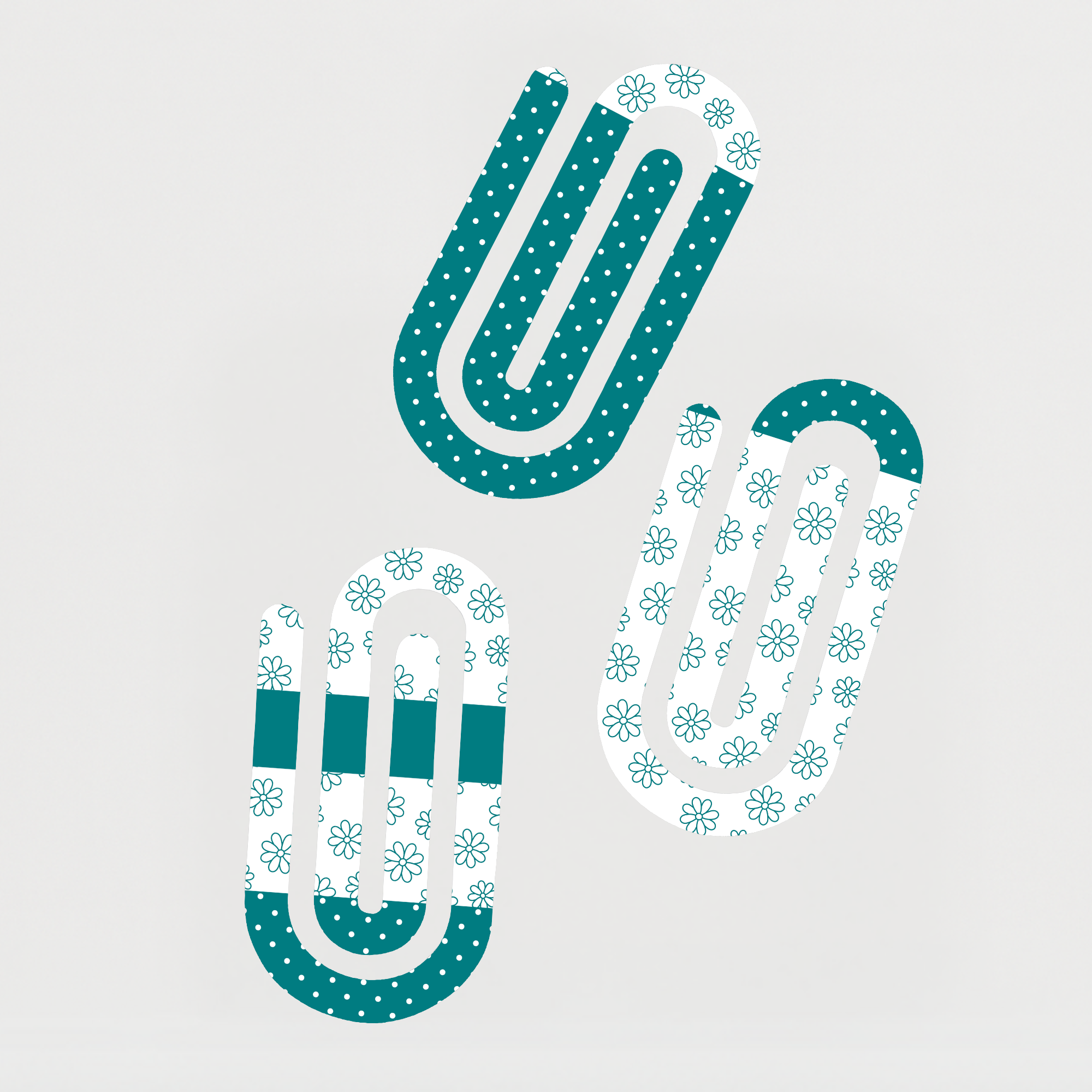 Teal jumbo paperclips with floral and polka dot designs displayed on a white background.