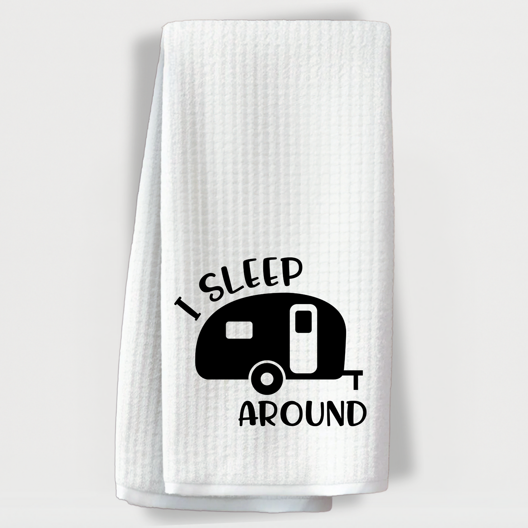 Camping towel with a small camper and the phrase 'I sleep around'.