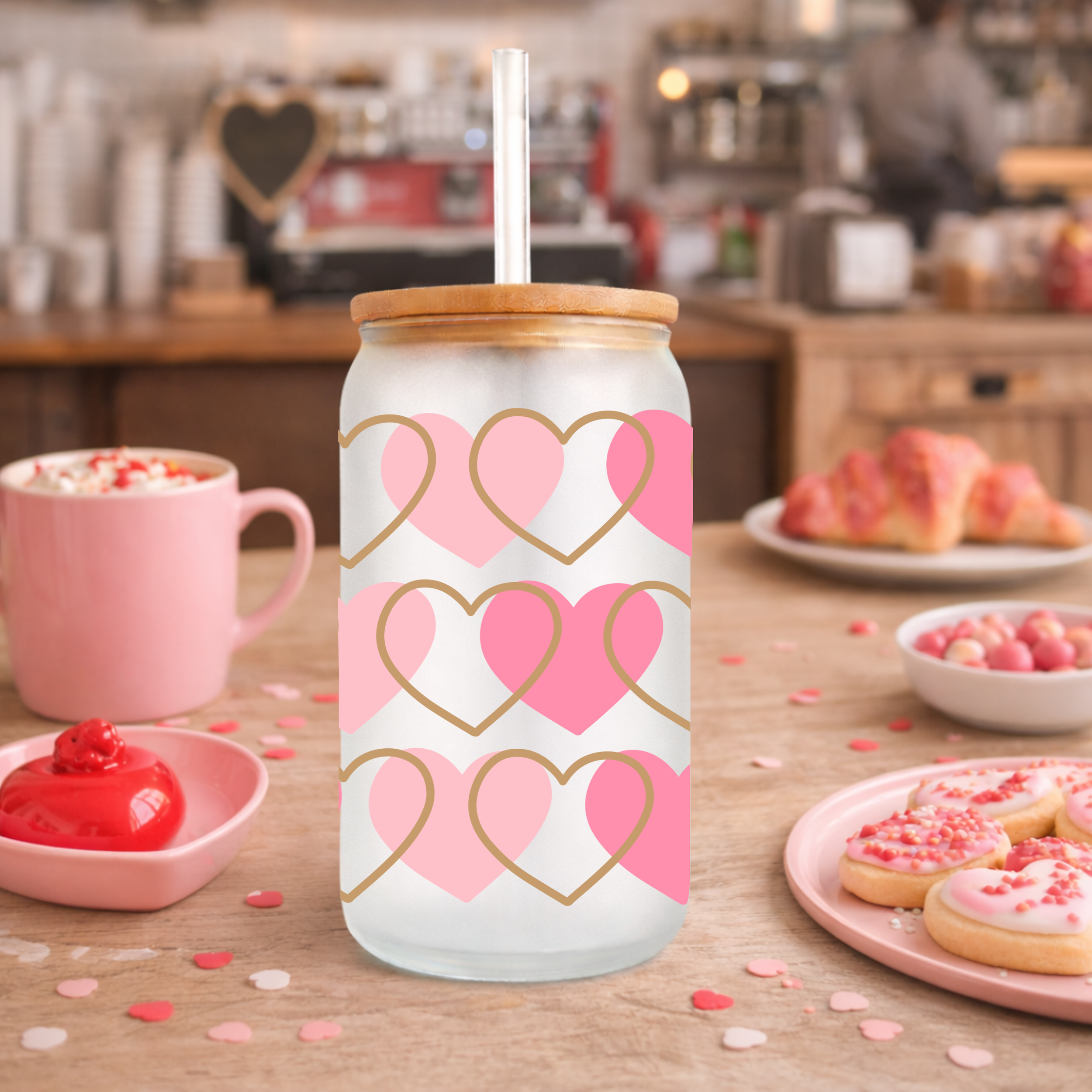 Photo 5 of a Valentine heart glass can cup styled on a café-style counter with pink treats and mugs.