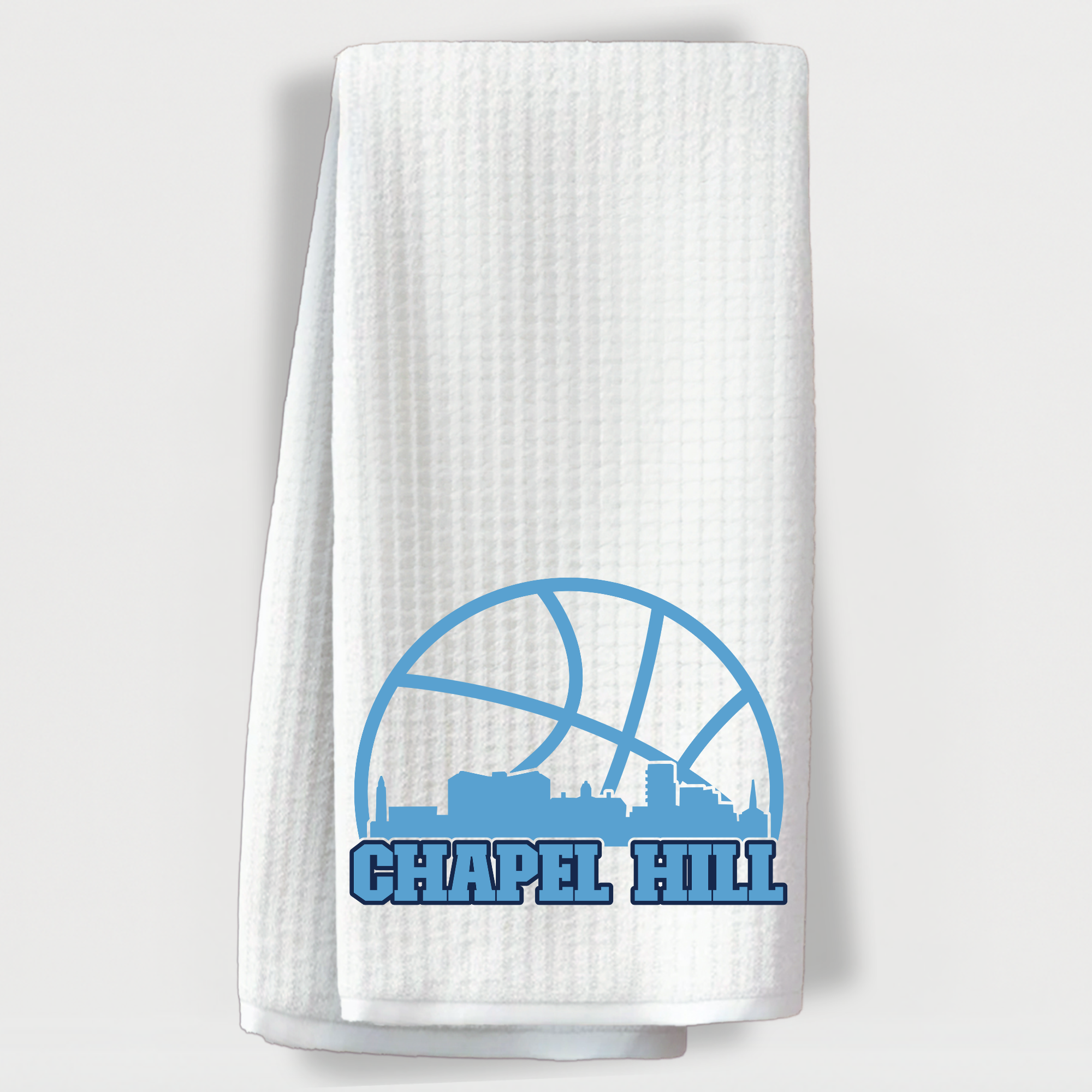 UNC Chapel Hill-themed towel with blue basketball and campus skyline design.